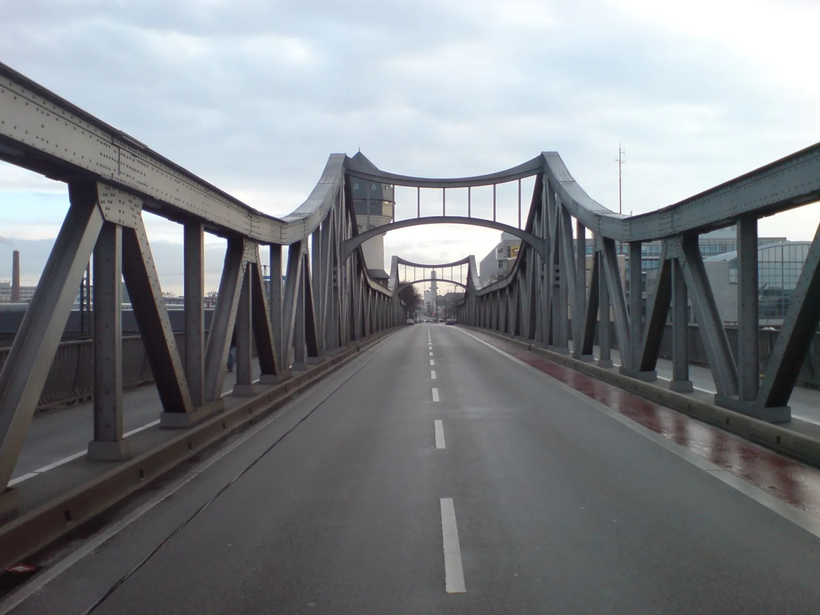 Photo showing: The bridge over the northern part of the Darmstadt Hauptbahnhof, in Darmstadt, Germany. An old water tower is in the background. Looking east.