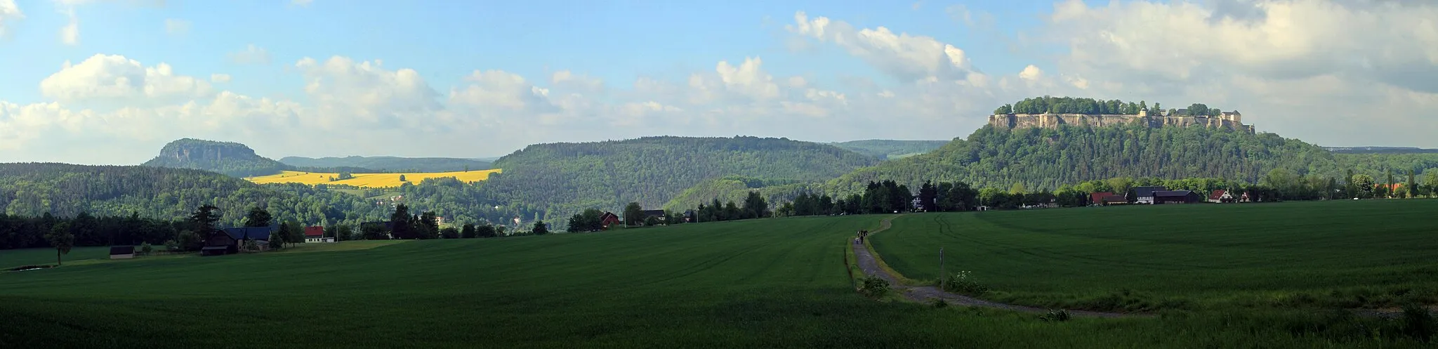 Photo showing: this image shows three mountains of the Saxony Switzerland: Königstein Fortress (right), Quirl (middle) and Pfaffenstein (left).