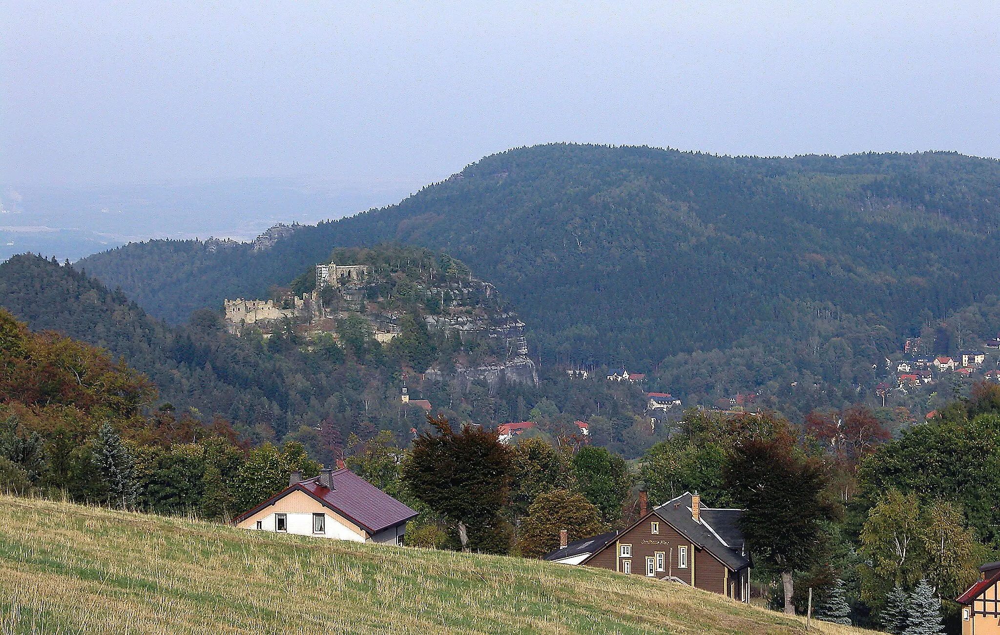 Photo showing: 01.10.2003   Kurort Oybin: Fernsicht vom Johannisstein in Tschechien nach Nordosten zum Burgberg Qybin. Die Reste der heutigen Burg mit dem Kaiserhaus (GMP: 50.844149,14.740835) wurden ab 1364 auf Befehl des Kaisers Karl IV. errichtet. Von 1366 - 1384 errichteten die Cölestinermönche die Klosterkirche. Die Besiedlung des Berges wurde später wieder aufgegeben. Jahrzehnte danach wurden die Bauten durch Blitzschlag zerstört.                                                                                                                                                                                                                                                                                                                             [DSCN]20031001500DR.JPG(c)Blobelt