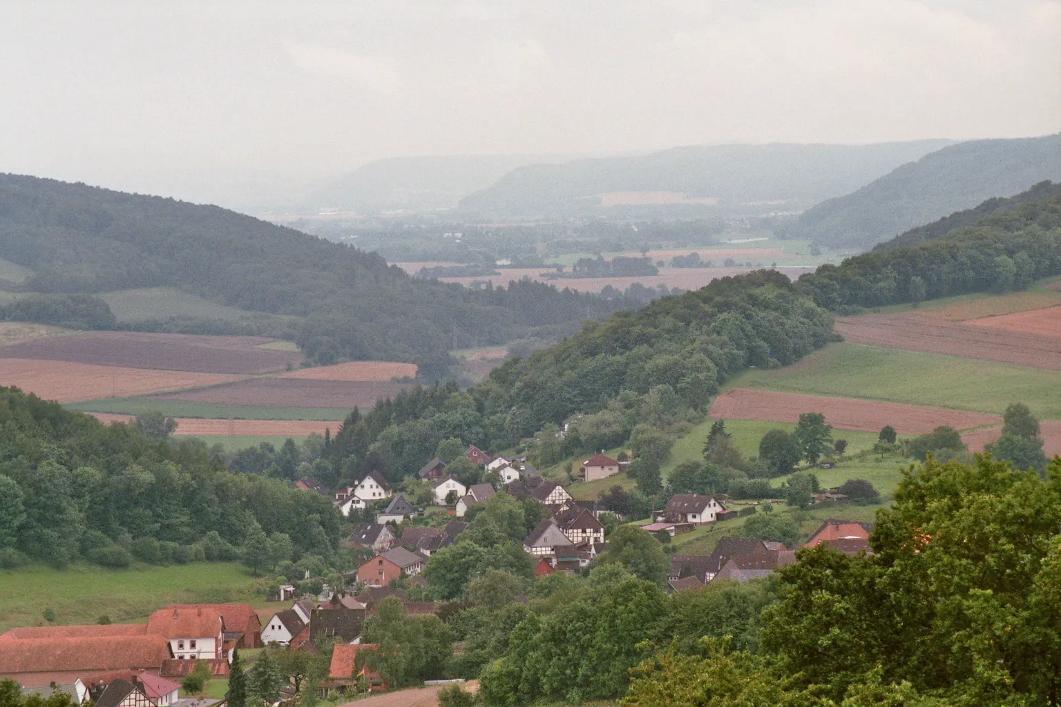 Photo showing: Das Dorf Lütgenade und das Wesertal von der L580 in der Rühler Schweiz aus gesehen.
Panorama with the  village Lütgenade and the Weservalley
Camera: Canon Eos 3000
Film: Fujifilm Superia X-tra 400 ISO

Lens: Tamron AF70-300mm