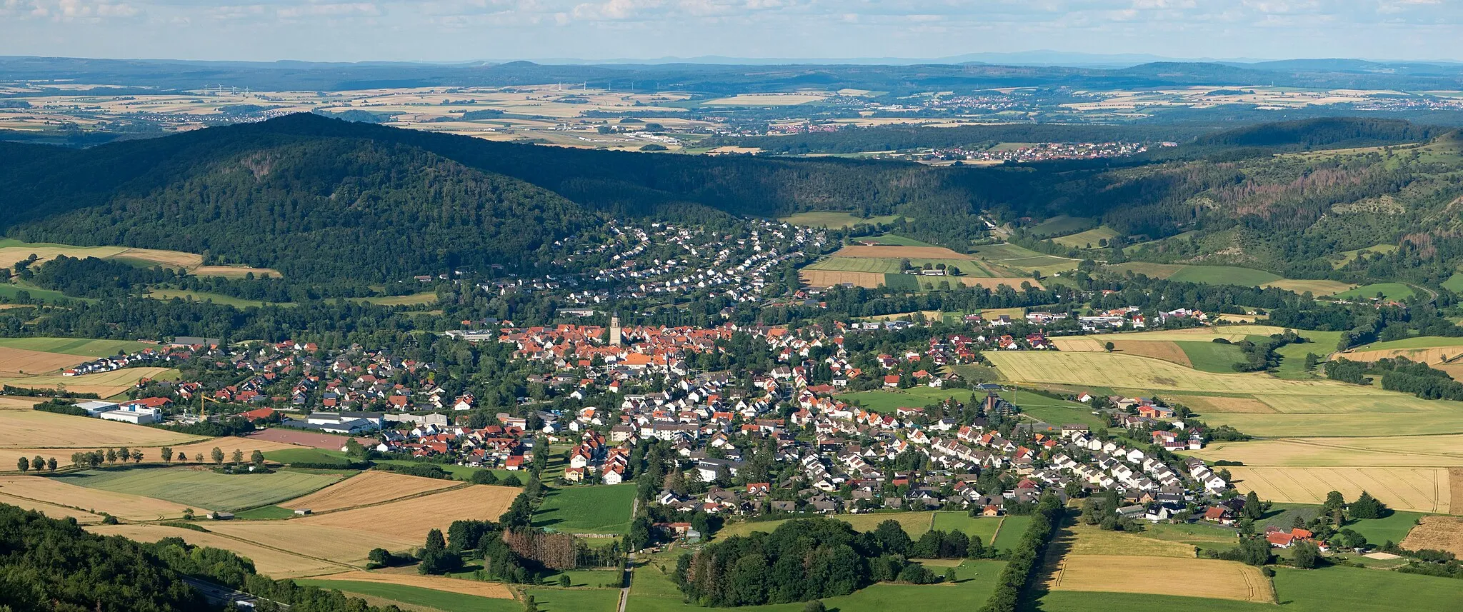 Photo showing: Zierenberg seen from the Großer Bärenberg. In the background the Brocken in a distance of 106 km
