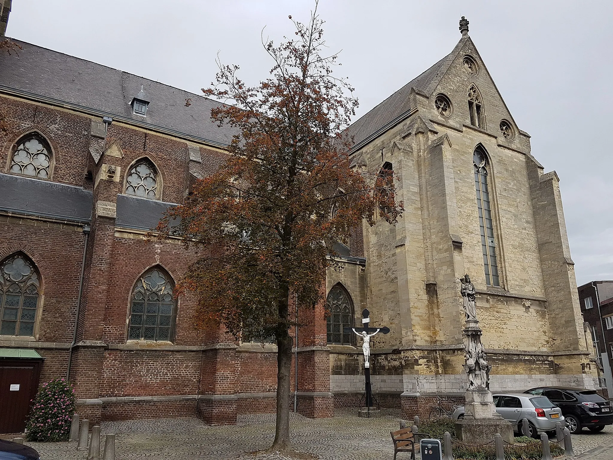 Photo showing: View of the medieval parish church of Saint Peter in the centre of Sittard, the Netherlands. In front of the church is a crucifix and a monument to the Virgin Mary.