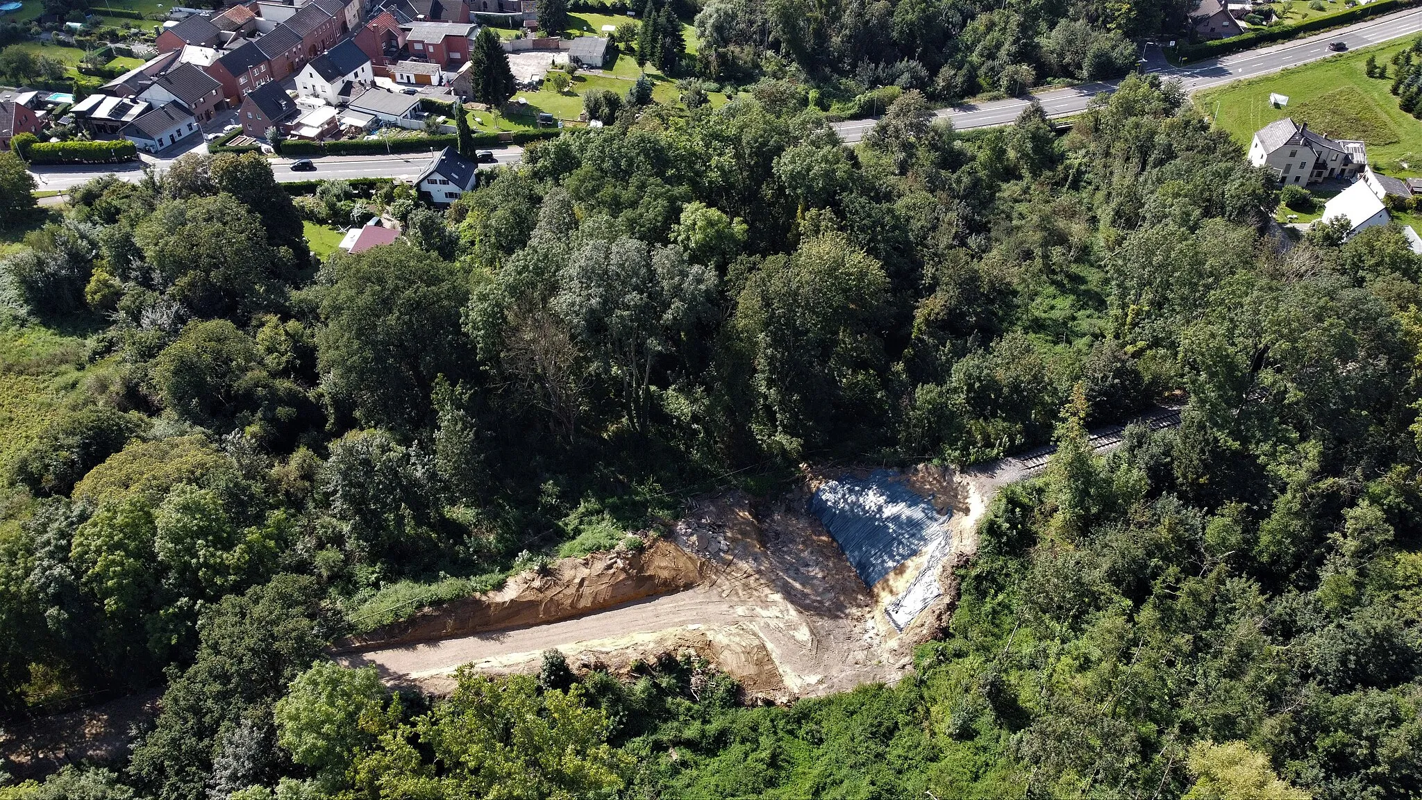 Photo showing: Etwa 200 m nördlich des Haltepunkts Tetz überquerte die Bahnstrecke Jülich - Linnich mittels einer kleinen gemauerten Brücke den Malefinkbach. Die Brücke stammte aus der Bauzeit der Strecke (um 1910), der Bach indes führt seit mehreren Jahrzehnten nur noch sehr selten Wasser. Am Abend des 7. März 2020 musste die Brücke wegen massiver Setzungsschäden gesperrt werden. Am folgenden Montag (9. März) wurde sie von Sachverständigen untersucht. Im Laufe der folgenden Monate zeigte sich, dass eine Reparatur unmöglich war, so dass die alte Brücke abgerissen und eine neue errichtet wurden. Das Foto zeigt den Stand der Bauarbeiten im September 2021, Blick nach Westen mit den Häusern von Tetz. Die Rurtalbahn richtete für den den gesperrten Abschnitt Tetz - Linnich einen Schienenersatzverkehr mit Bussen ein. Im Dezember 2021 wurde auf den Fahrplanaushängen des Ersatzverkehrs dessen Ende für den 24. April 2022 angekündigt.