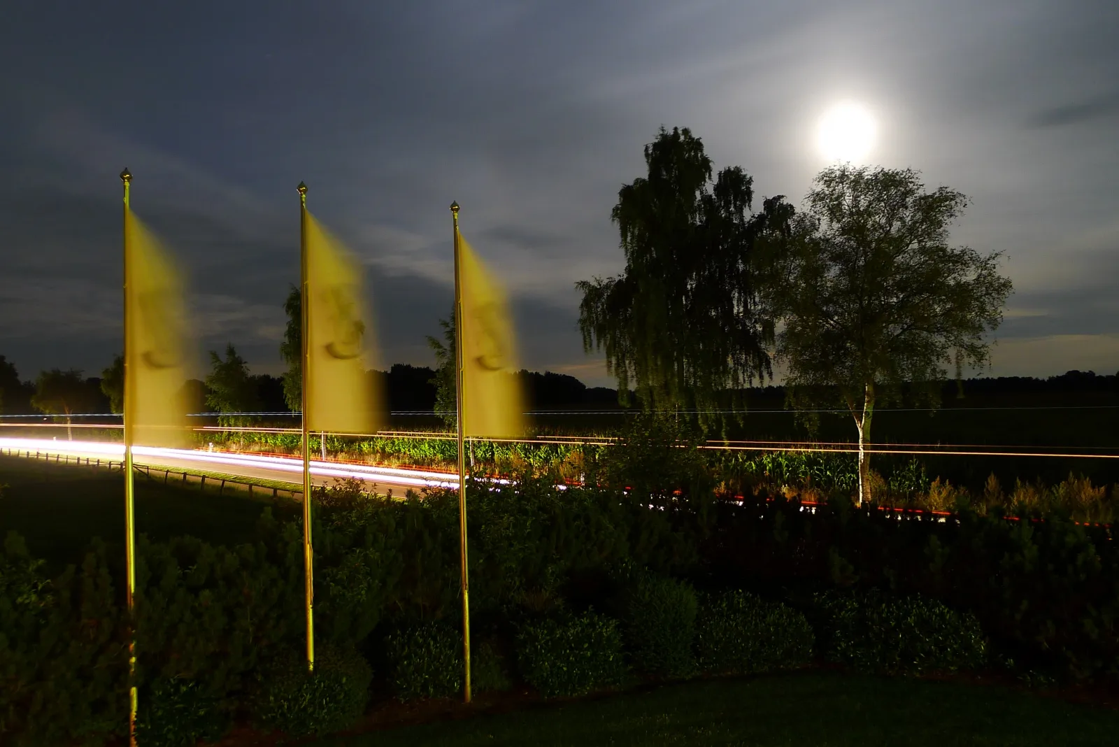 Photo showing: Flags from the hotel fluttering in the breeze at night. Groß Meckelsen, nr Sittensen, Germany