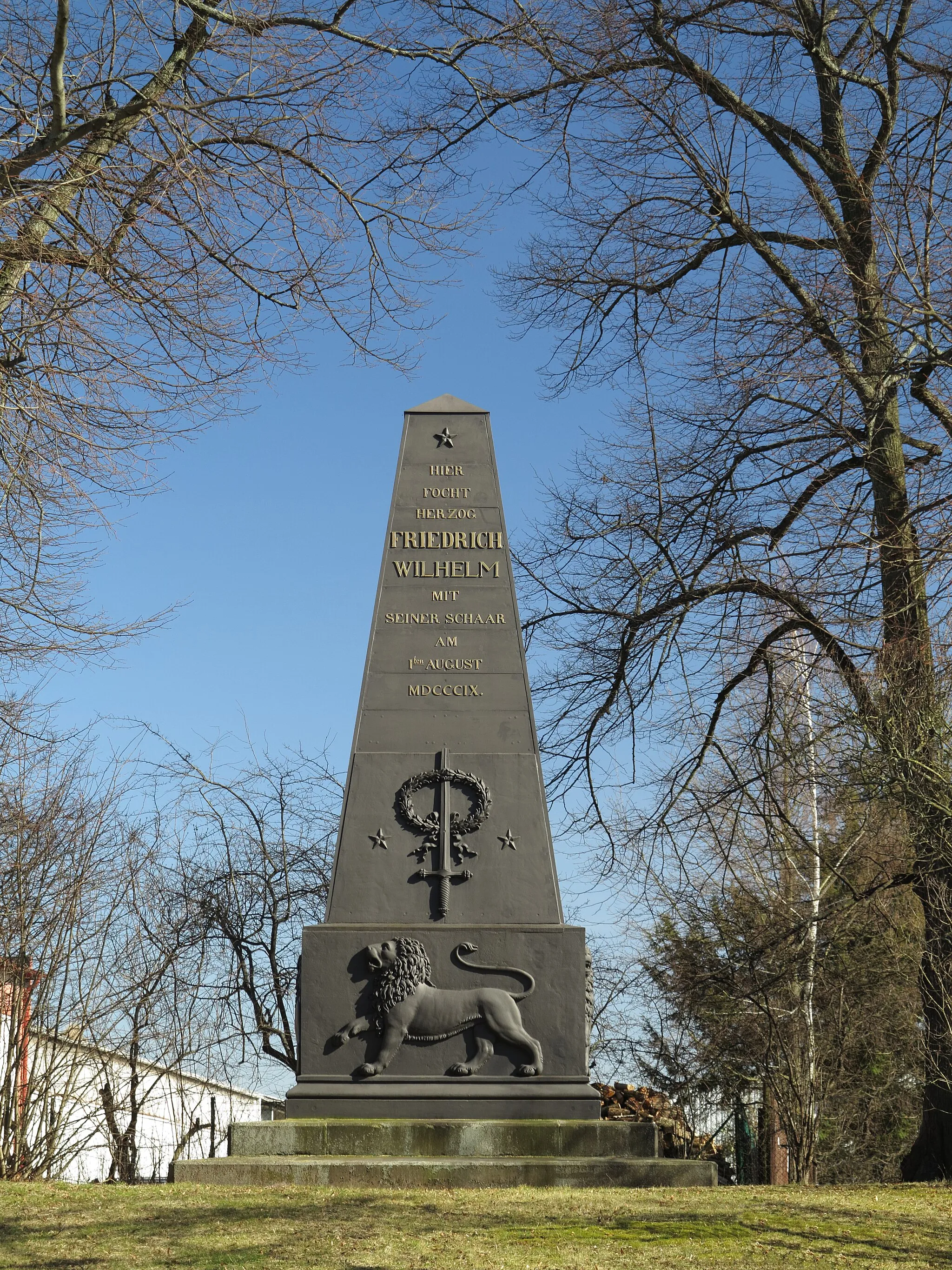 Photo showing: Ölper: The cast iron obelisk commemorating the Battle of Ölper. It's erection was suggested by William, Duke of Brunswick and it was inaugurated on October, 15 1843. The inscription reads: „Here Duke Friedrich Wilhelm fought with his troop on August, 1 1809”.