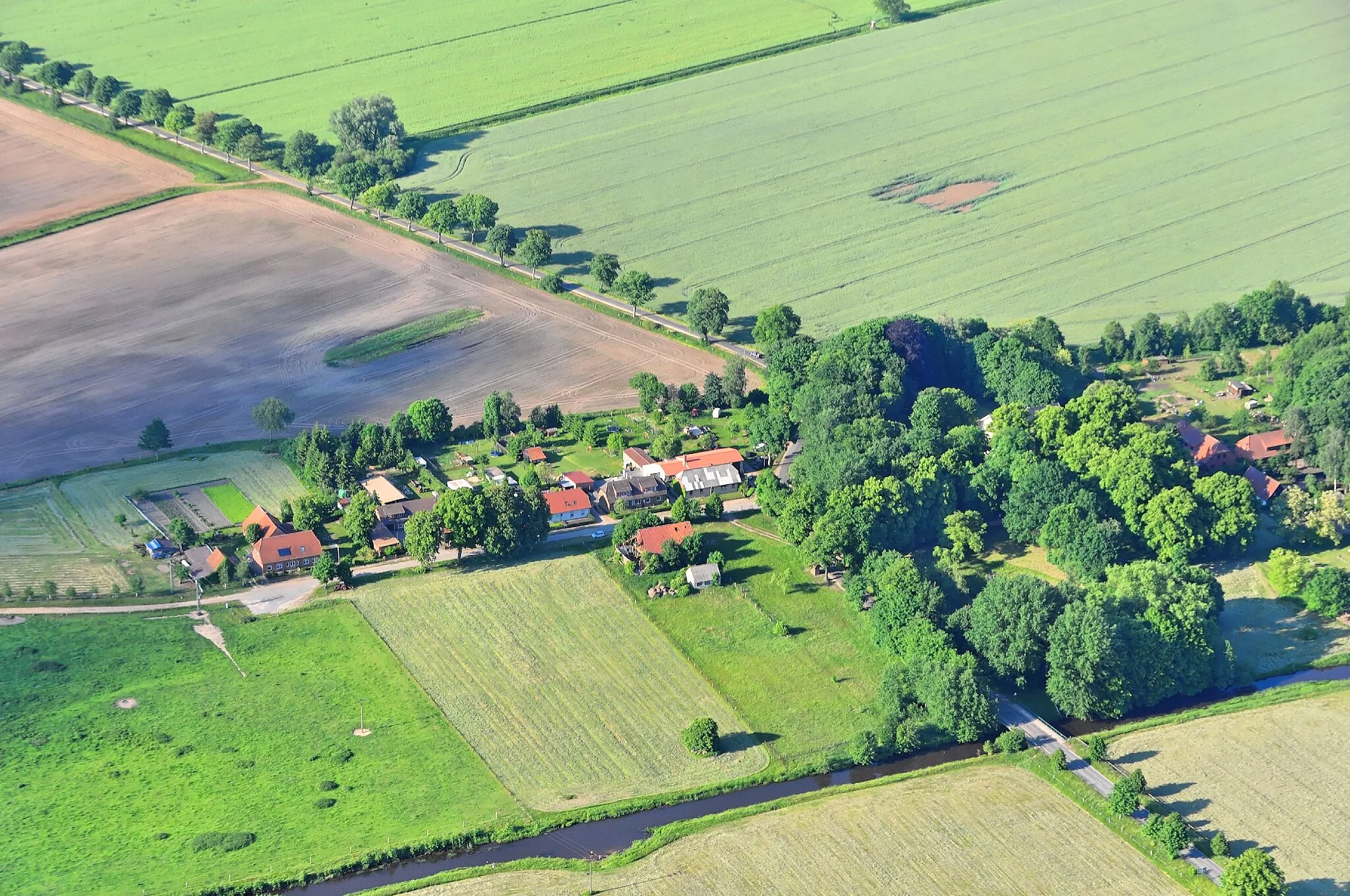 Photo showing: Überführungsflug vom Flugplatz Nordholz-Spieka über Lüneburg, Potsdam zum Flugplatz Schwarzheide-Schipkau. Hier: Die Schmiedestraße des Lübtheener Ortsteils Garlitz mit den anliegenden Gebäuden und der Umgebung. Am Ende (rechts im Bild unter den Bäumen) die Anlage des unter Denkmalschutz stehenden Gutshauses.