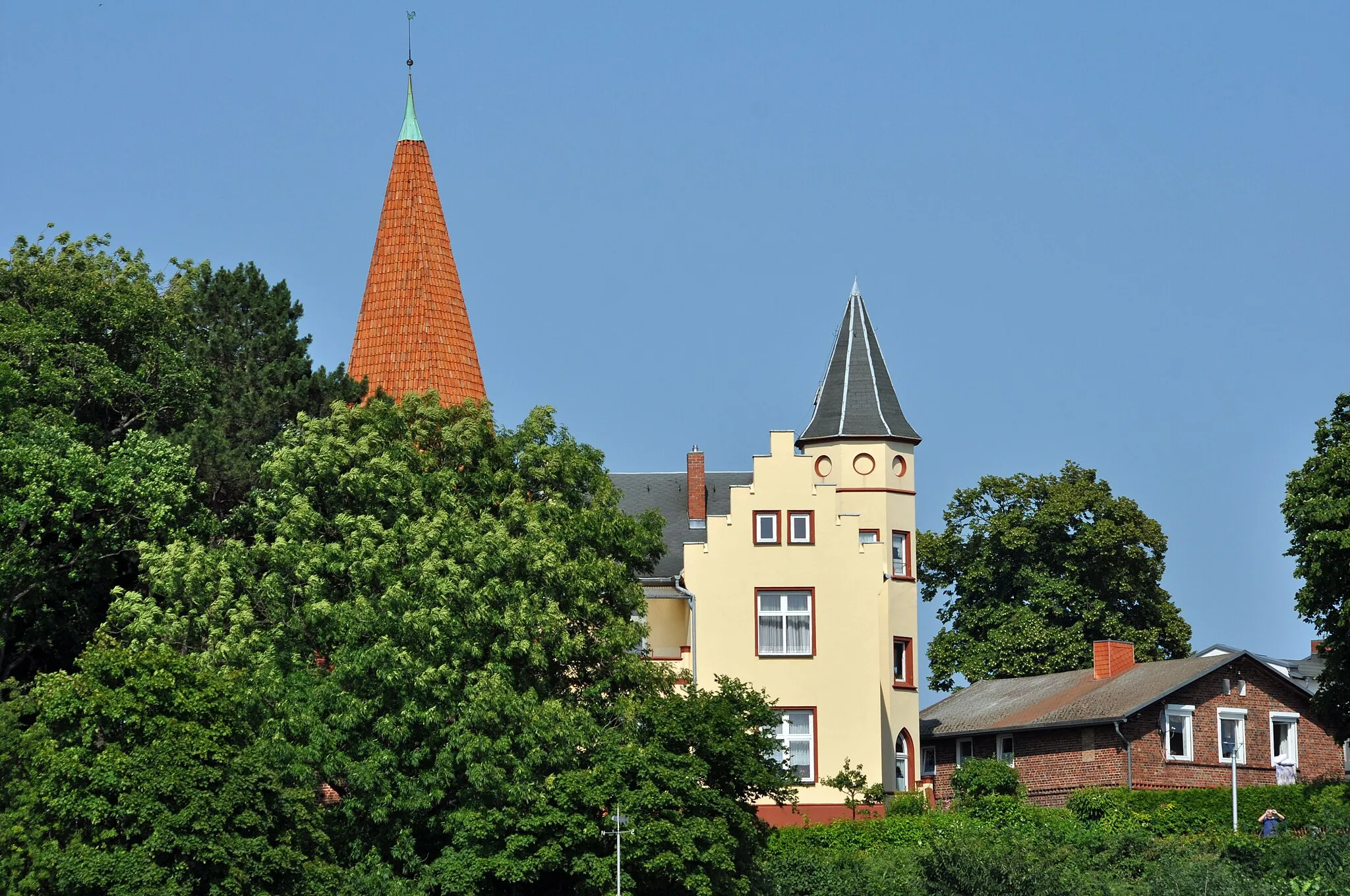 Photo showing: Fotografiert vom Turm der Marienkirche in Stralsund.

Altefähr, aufgenommen vom Fähranleger am Hafen. Kirchturmspitze und Haus Kirchweg 7 (beide eingetragen als Baudenkmal Nr. 5 und 6).