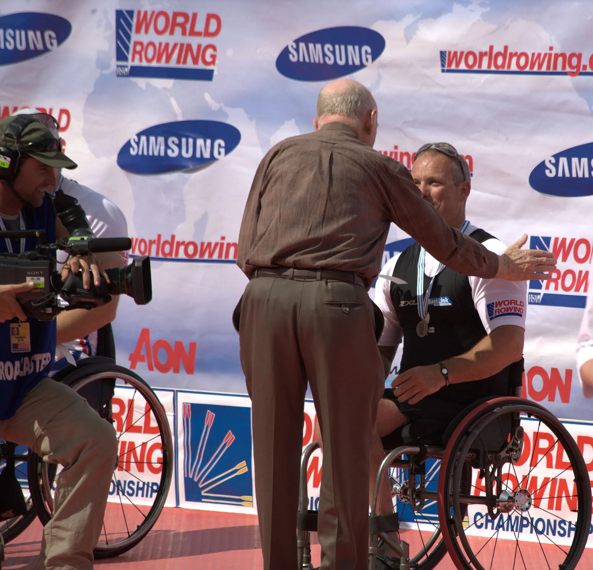 Photo showing: Sir Murray Halberg congratulates Danny McBride.
2010 World Rowing Championships.