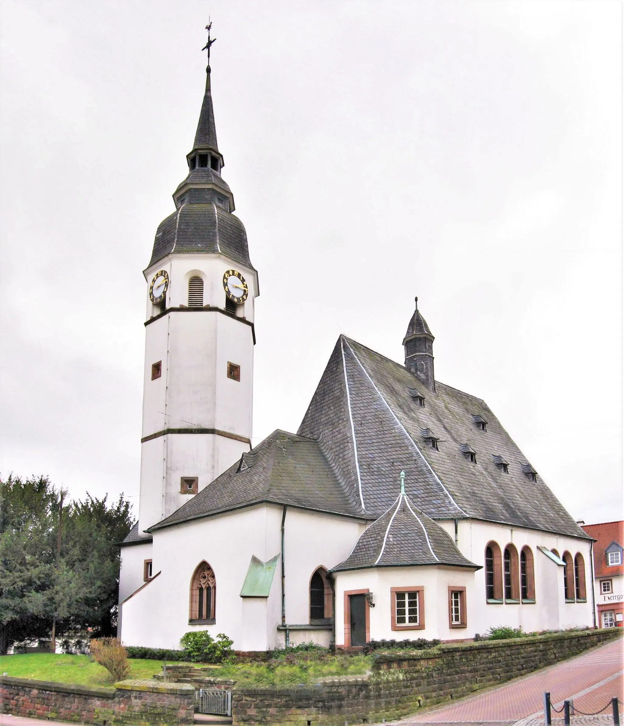 Photo showing: Barocke evangelische Kirche in Heusweiler. Früheste Zeugnisse stammen aus dem 12. Jahrhundert. Die Pfarrei "Husiler" wird 1330 erwähnt. Im Zuge der Reformation wurde die Kirche am 31.10.1575 lutherisch, dokumentiert im Pfarrregister von 1576. Von beiden Konfessionen wurde die Kirche ab 1685 bis zum Neubau der katholischen Kirche (1862) genutzt. Bei der Renovierung 1911 blieb der Chor aus dem 15. Jahrhundert erhalten. Das ursprüngliche barocke Kirchenschiff von 1719 wurde ersetzt. Sakristei und Turm wurden am Chor angefügt. Im klassizistischen Stil wurde der Kircheneingang gestaltet. Der Grabstein des den Neubau vorantreibenden Pfarrers Gustav Weber ist rechts vom Eingang angebracht.