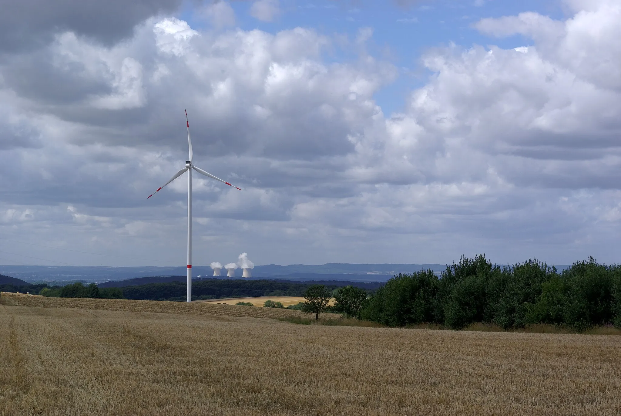 Photo showing: Nuclear power plant Cattenom and a wind turbine seen from Borg in Germany (Saarland)