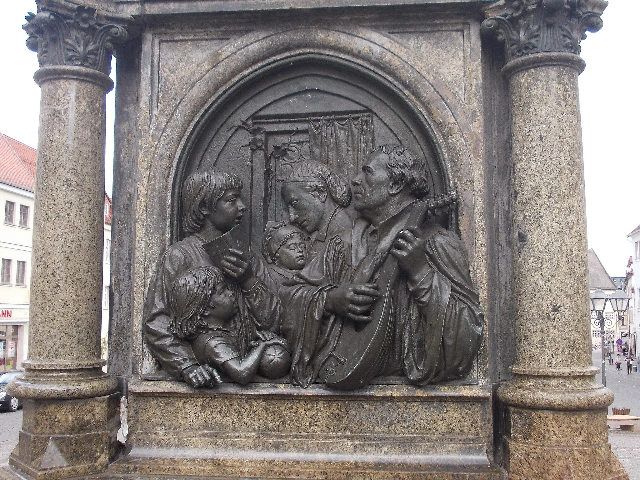 Photo showing: A relief of the Martin Luther Memorial in Eisleben (Mansfeld-Südharz district, Saxony-Anhalt): Martin Luther within the family