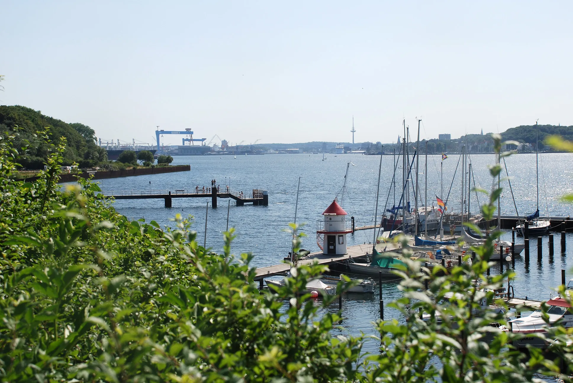 Photo showing: Blick von der Germaniakoppel auf den Hafen von Mönkeberg und auf die südliche Kieler Förde. Rechts hinten das Westufer mit der Altstadt von Kiel, links im Hintergrund HDW (Howaldtswerke-Deutsche Werft) mit den zwei Portalkränen