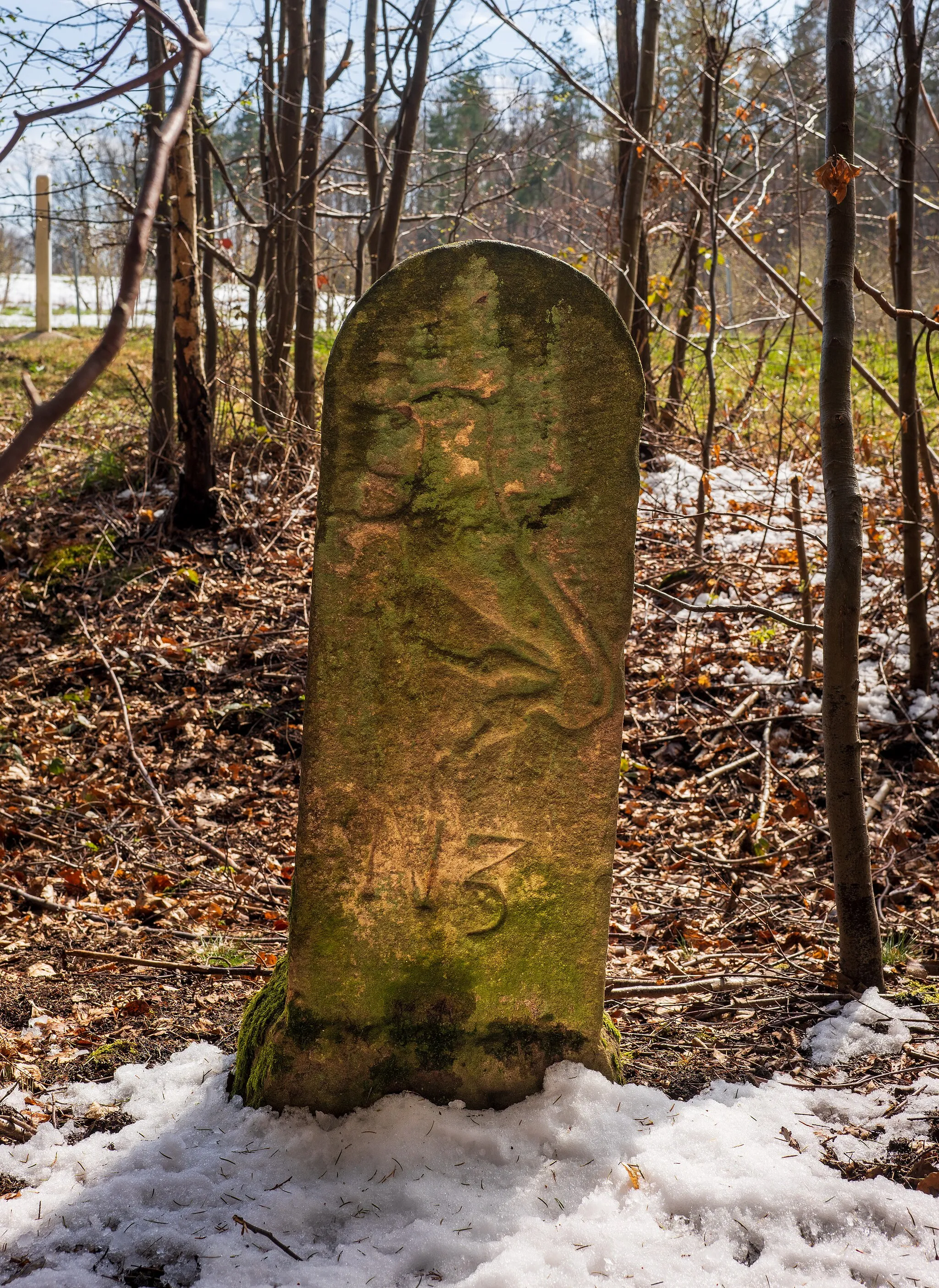 Photo showing: Beilstein, Württemberg, Germany: very old boundary stone northwest of the hamlet Stocksberg at the edge of the forest at the K 2098. (More exactly, the stone is located ca. 2 m from the edge inside of the forest; therefore you can see it only in the winter.) The stone marks the border between Beilstein or (formerly) Württemberg (therefore the other side shows an antler) and Löwenstein (therefore the northeast side depicted here shows a lion).
