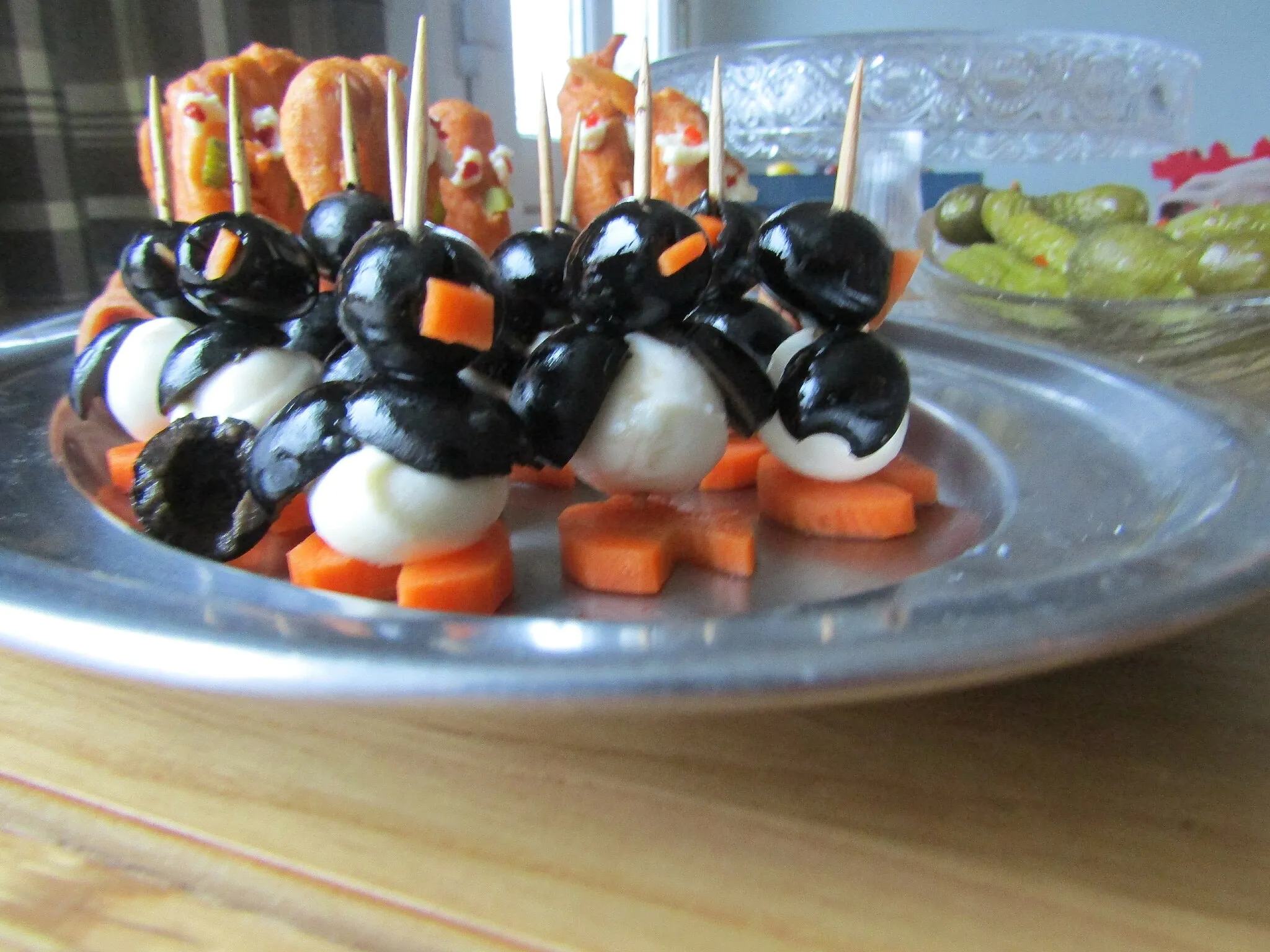 Photo showing: Penguins made of mozzarella, carrot and black olives, prepared for a New Years Eve party in the town of Cromer, Norfolk, England.