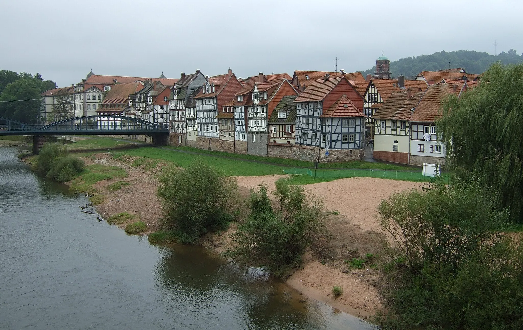 Photo showing: Historische Häuserzeile in Rotenburg (an der Fulda). Stehend aufgenommen von einer der Brücken aus mit Blick gegen Süd-Ost. Links im Hintergrund zu erahnen sind das Sperrwerk und die beiden Türme vom Schloss, weiter in der rechten Bildhälfte der Turm der evangelischen Stadtkirche.