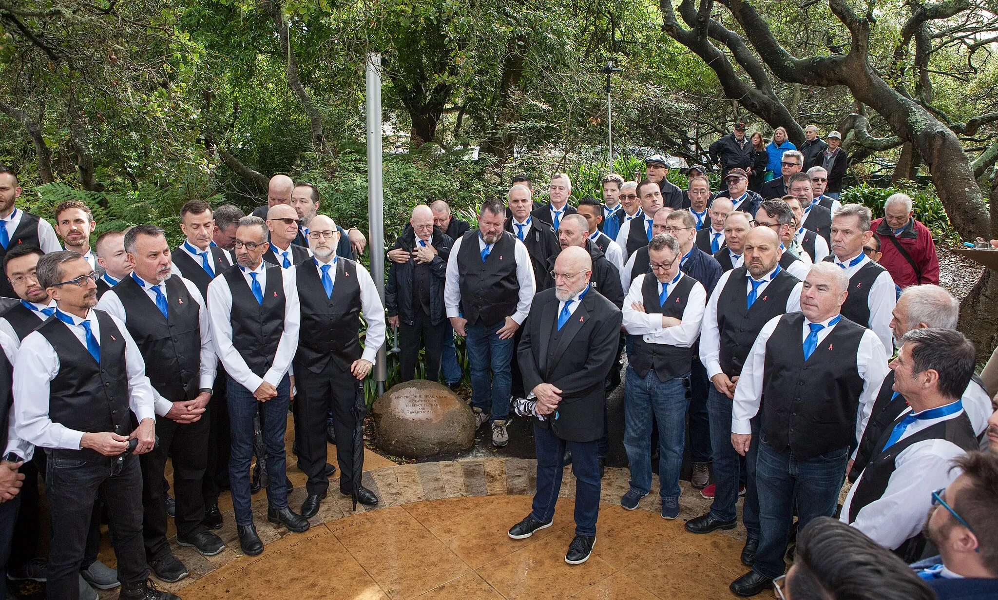 Photo showing: Members of the San Francisco Gay Men's Chorus gather at the Artists Portal at the National AIDS Memorial Grove on World AIDS Day, 2018.