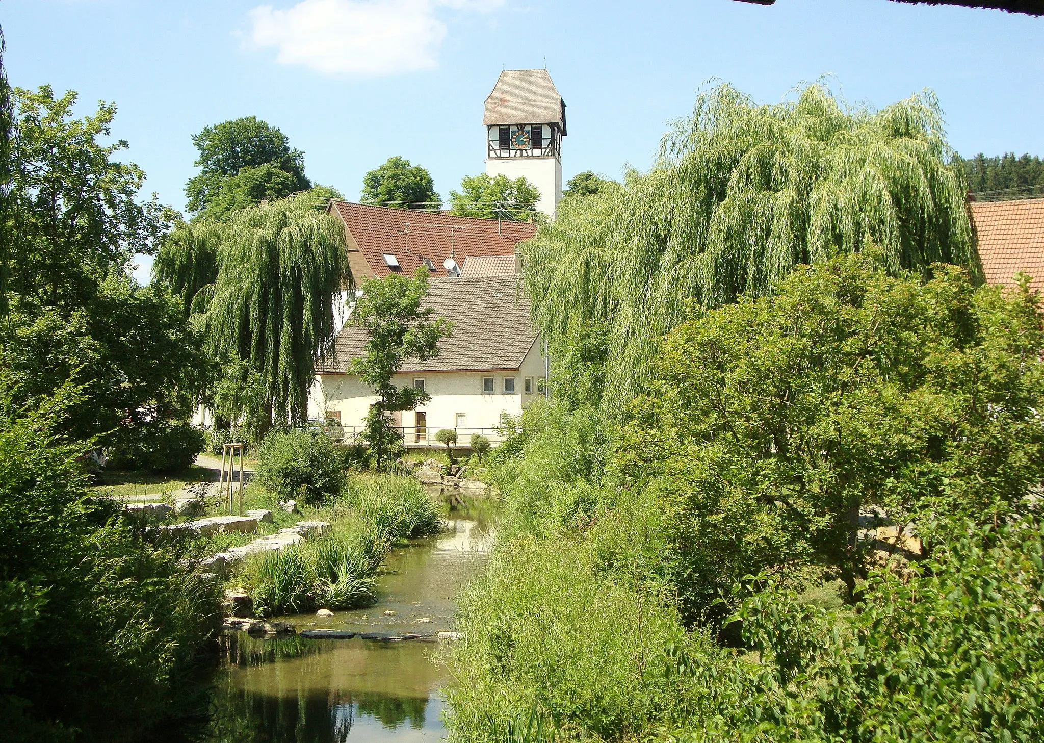 Photo showing: View on the stream Schlichem and the church tower of St. Verena church Dautmergen