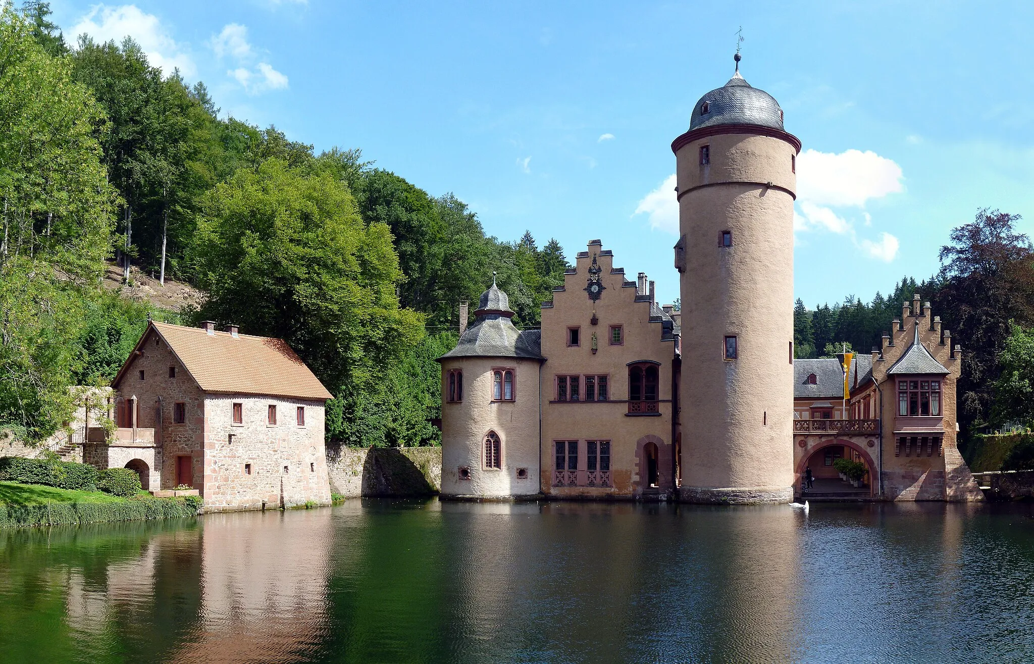 Photo showing: The Mespelbrunn Castle, a moated castle on the territory of the town of Mespelbrunn, is situated remotely in the Elsava valley in the Spessart (between Frankfurt and Würzburg). Since the early 15th century it has been owned by the family Echter of Mespelbrunn. The oldest parts were built in 1427, the current appearance was created from 1551 to 1569.
The castle was location of the 1958 German comedy film The Spessart Inn with the famous German cinema actress Liselotte Pulver. Consequently it gained  nationwide popularity. It is one of the most visited moated castles in Germany and is frequently featured in tourist books. The annual numbers of visitors are just under 100,000.