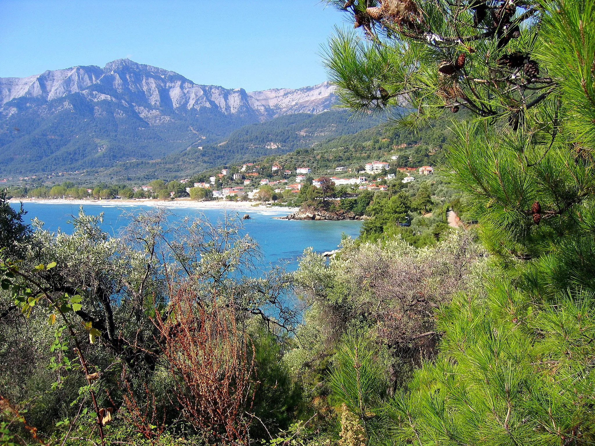 Photo showing: Looking towards Scala Panagia with Mount Athos in the background.My Yacht is anchored behind the bushes. Don't want to attract pirates do we ? Ron.