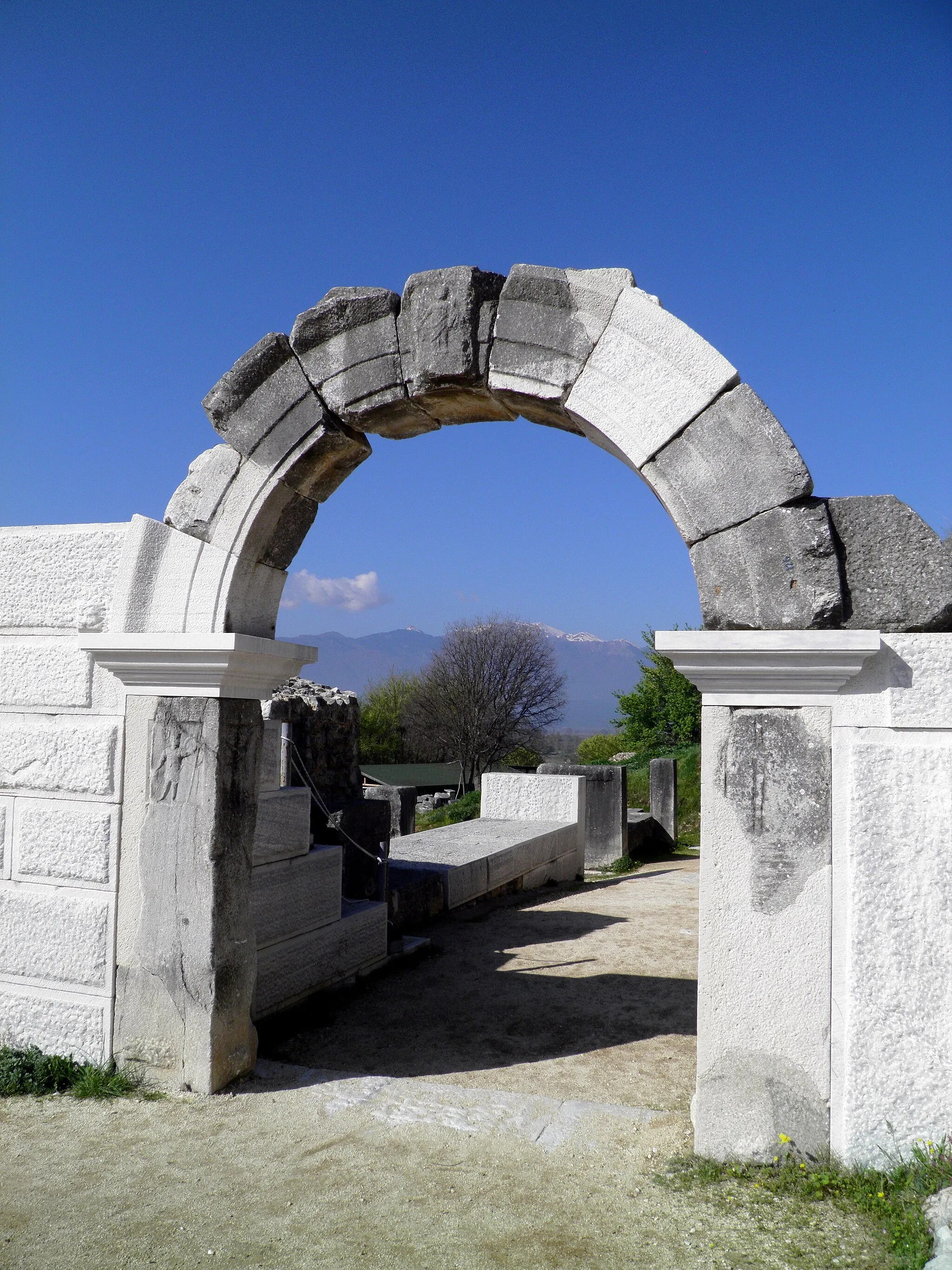 Photo showing: The ancient Theatre of Philippi is a remarkable and important monument. It is located at the foot of the acropolis and it is supported on the eastern wall of the city of Philippi. Even though it has undergone many changes over the centuries and some interventions it still preserves many of its original elements.
The first phase of the theatre dates back in the reign of Philip II in 356 BC. At that time the orchestra was u-shaped.
During Roman colonization changes were made to the theater in order to become suitable for the requirements of the new shows. The orchestra was floored with marble slabs and a high wall was built to protect the spectators during beast fights. Eventually in the 3rd Century A.D. the Theatre becomes an arena for beast fights.
During the Christian times the habits and morals of the people changed so the theater was abandoned.

Nowadays, many parts of the theatre are saved untouched still many restoration works are done so the annual Philippi Festival can take place.