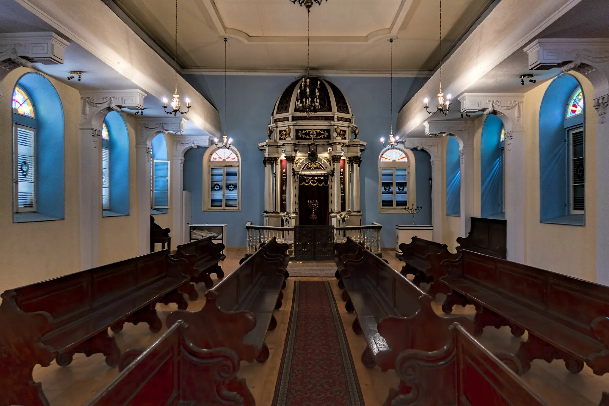 Photo showing: The ark holding the Torah at one end of the main worship space up the stairs inside the only remaining synagogue in Corfu which was built in the 17th century CE in Venetian style.  In the 19th century CE around 4,000 Jews lived in Corfu.  Today there are only about 60.
The island of Corfu—known as Kerkyra in Greek—is strategically located at the entrance to the Adriatic Sea.  Regularly fought over, the Romans gained control in the 3rd century BCE, continuing with the Byzantine Empire (eastern portion of the divided Roman Empire) from the 4th century CE.  In 1386 CE the Venetians took over.  They held off multiple attacks from the Ottoman Turks.  In 1797 CE Napoleon Bonaparte secretly negotiated the end of the Republic of Venice bringing Corfu under French rule.  All the Ionian Islands became a British protectorate in 1815 CE until being ceded to Greece in 1864 CE.
The Old Town of Corfu was designated a UNESCO World Heritage site in 2007.
On Google Earth:

Scuola Greca (Greek Temple) Synagogue  39°37'23.10"N, 19°55'11.92"E