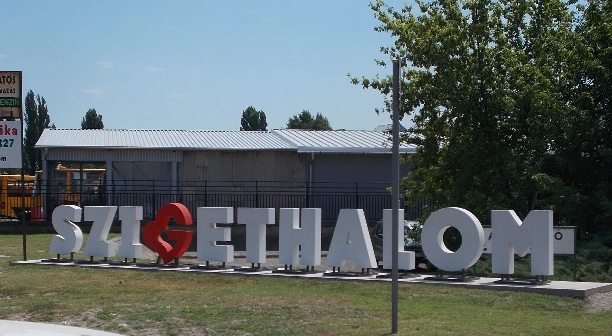 Photo showing: : City name sign before the bus depot. - Mű út (Road 51104), Szigethalom, Pest County, Hungary