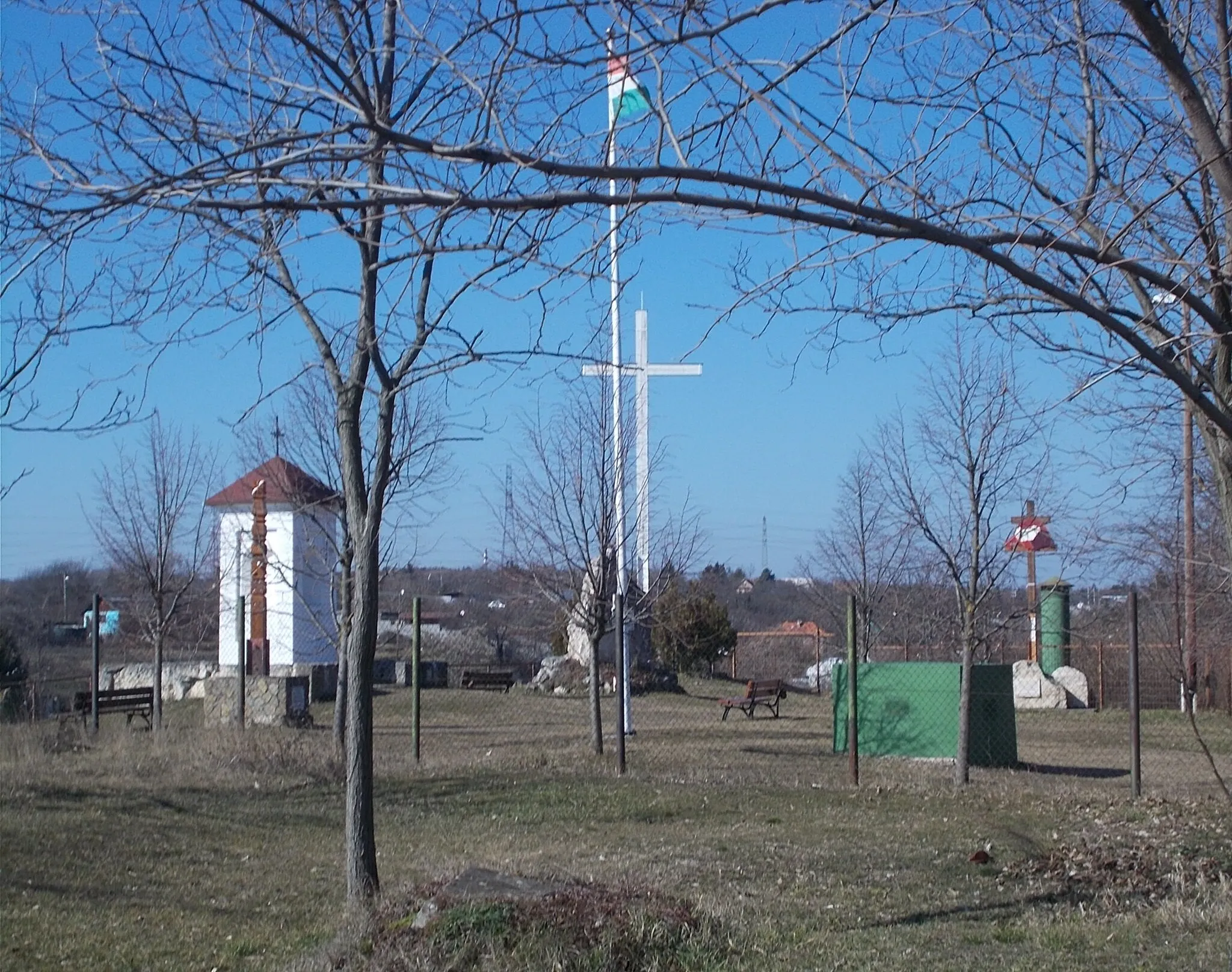 Photo showing: ~Donát Hill Memorial Place. A local vineyard owner, the Medetz family built here in the 1850s (1860s?), on Donát Hill /Saint Donatus/ first a 'painting holder/painting column' it is a shrine with four niches with Saint Donatus painting(s?). Under WWII this shrine demolished. In the 1990s reconstructed. Later this small plateue remodelled to a Memorial Place. Now here are not only the shrine, but a memorial stone with turul ststue, Trianon memorial with double cross, a flagpole, kopjafa and a 3-4 meters high lighting cross - Mária Street, Baross Gábor-telep neighbourhood, District XXII of Budapest. - Mária Street, Baross Gábor-telep neighbourhood, District XXII of Budapest.