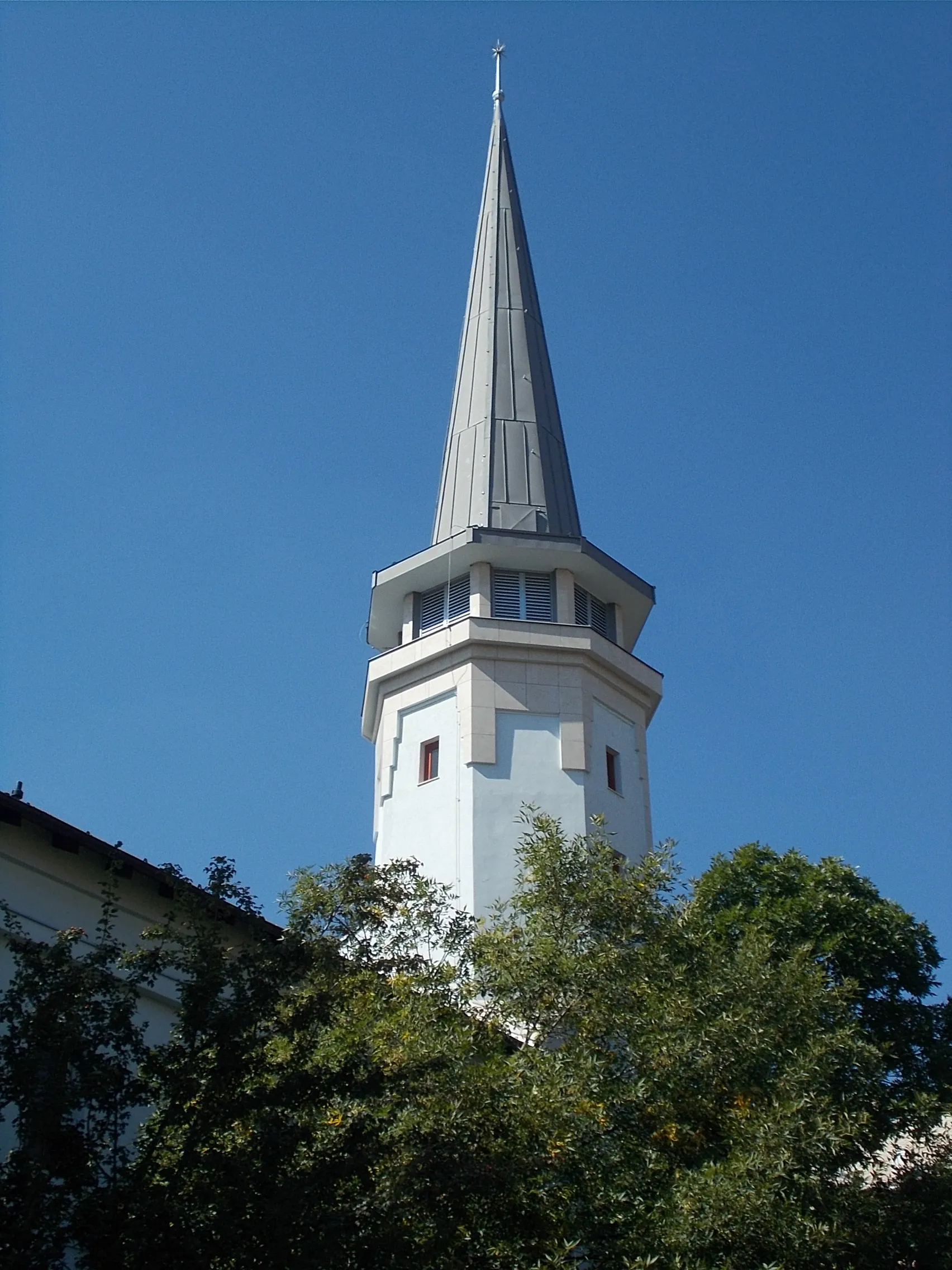 Photo showing: Budahegyvidéki Reformed Church (Est 1931). The community house was the former “Claridge” restaurant and café Architect: Lajos Wanda. Built in 1932.  In 1995 gallery built and a 33m high, 'transylvanian-like' tower  Architects: Mária Nyíri and László Varga. Furniture planned (partly made too) by designer György Fekete. Pulpit and wooden ceilings are József Barabás Transylvainan woodcarver works. Steel belfry in the garden 1948 works. - Beethoven Street and 28 Böszörményi Road corner, Németvölgy neighbourhood, 12th district of Budapest.