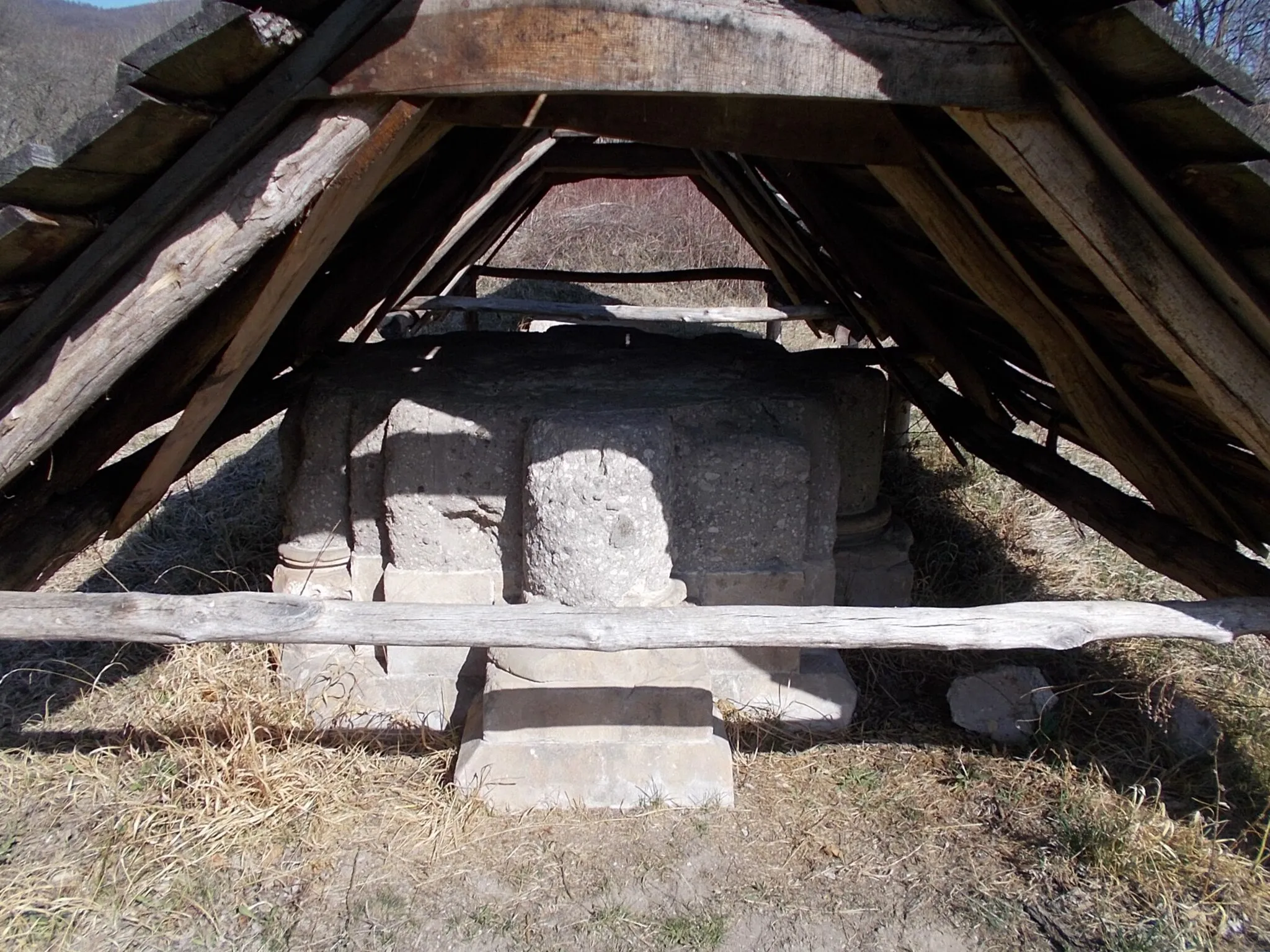 Photo showing: Pilis Abbey, cloister column remain. This place originally consisted of a 11th-century complex of buildings surrounded by a village inhabited by the early Árpád period. Béla III of Hungary (1172-1196) founded the Cistercian monastery in 1184. At first, the buildings here were transformed and expanded according to the needs and ideals of the order. The Cistercians were happy to settle their monasteries away from the settlements- they insisted on poverty and simplicity. They wore white clothes, protected by a black apron at the front and back, and settled in Hungary in 1142. The first monks came from the Acey Abbey, France to Pilis. Béla is believed to have founded a Cistercian monastery near the royal court for the sake of his French wife, the constructions were completed around 1225 at the time of the consecration of the monastery church. The monastery was built at the same time as the cathedral and palace of Esztergom. The Cistercian abbey was created by French architects with a similar mindset as those who worked on the palace chapel in Esztergom. The world-famous Villard de Honnecourt was here, but there is no evidence that he worked on the complex. Nevertheless, it is certain that the beginnings of Gothic architecture in Hungary were closely related to the French. This is why the remains of the Abbey of Pilis are very significant. Béla III and his successors presumably intended the monastery,-near the royal seat of Esztergom,-as a royal burial ground. This is evidenced by the fact that Andrew II of Hungary's first wife, Gertrude of Merania,-was murdered by Bánk bán and his associates -was buried here. The remains of his sarcophagus, together with the most significant finds, are currently on display in the Hungarian National Gallery. After the Tatar invasion Béla IV moved the seat of the country to Buda, so the importance of Pilis was overshadowed. In 1526, in the Turkish invasion following the Battle of Mohács, the monastery was also damaged, the monks fled. During the 16th century, the facility was completely depopulated. The ruins of the monastery are seven!? hectares are approved. In the 13th century, the most modern technology could be found here aqueduct transported the water of the nearby spring. Metal was processed in the well-equipped blacksmith's workshop According to the latest research, there was an ornamental well at the southeast wall of the cloister, which can be found in the western European monasteries of the time. In the middle of the 18th century, Slovak and German settlers arrived in the depopulated settlement. From then on, the ruin field was used as a quarry until the 20th century. The excavation of the site was carried out by László Gerevich between 1967 and 1982. Some of the finds were approved in a stone vault in the garden of the Roman Catholic parish. Research is currently underway in the area (2000s) (The sign was erected by the Pilisszentkereszt Somvirág Association and the Pest County Government in 2004) /info: based local information board, translated by Microsoft Translator/ - part of the green stripe walkway, yellow arrow pilgrimage/spirirtual walkway, part of Duna-Ipoly National Park, western outskirt of Pilisszentkereszt, Pest County, Hungary.