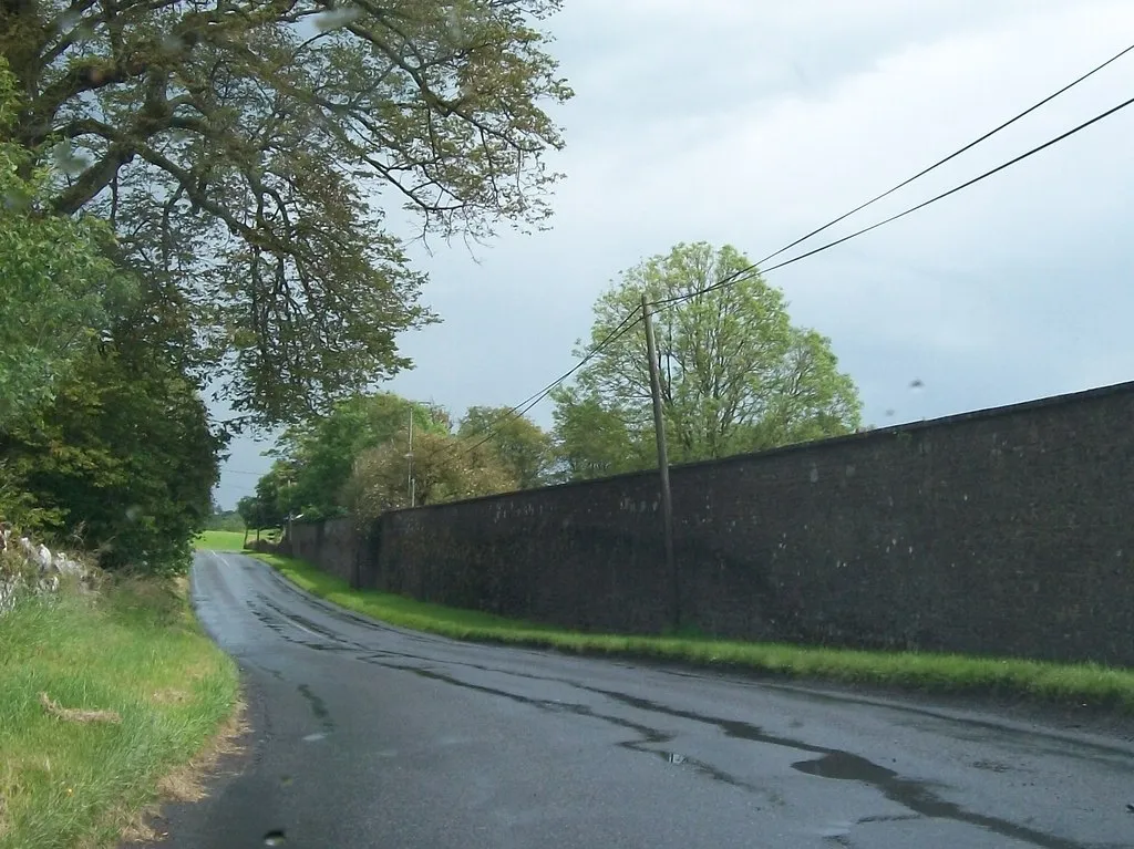 Photo showing: Public road running alongside the demesne wall of Loughcrew