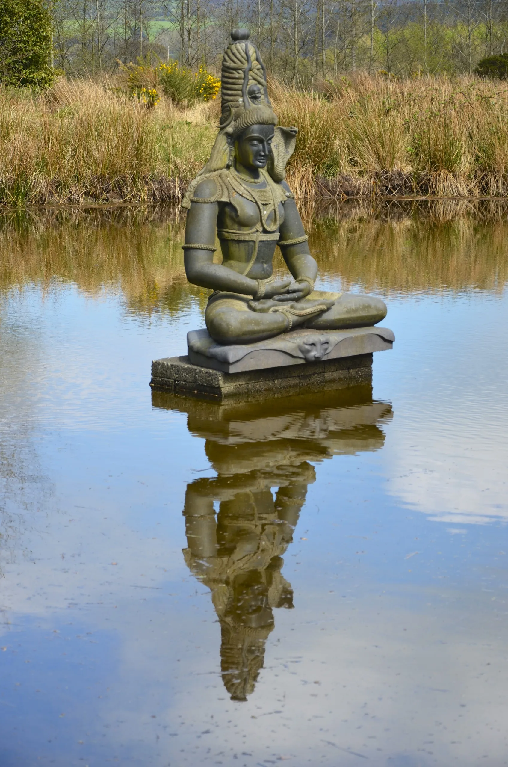 Photo showing: From the crown of his hair flows the river of creation, the Goddess Ganga (to wit, the Ganges). From his third eye he sends forth fire, the God Agni, and who destroys the world.
Shiva represents the maturing adult who is driven to solve the quandary of life, namely how to live life to the full, how to savour the reality of the most trivial moment while remaining fully attuned to the cosmic and metaphysical dimensions which threaten to reduce the moment to insignificance.
As married ascetic, Shiva lives out the extremes of life, now chaste, now sensuous; now controlling, now releasing; now destructive, now creative; now male, now female. In him, the sacred and the profane express to perfection. His life exemplifies in the extreme the essential urge to being and non-being, and to the deathless, hence the heart of all humans.
Shiva’s life provides no final and permanent solution, no synthesis, no balance, no rest, no peace. He expresses the realization that the real world, Samsara, results from dynamic interaction that creates order from chaos. Alone the frozen moment of action, whatever its shape, is perfect, true, real. Alas, that moment cannot last.
Indian sculpture park

Shramore, Wicklow, Ireland