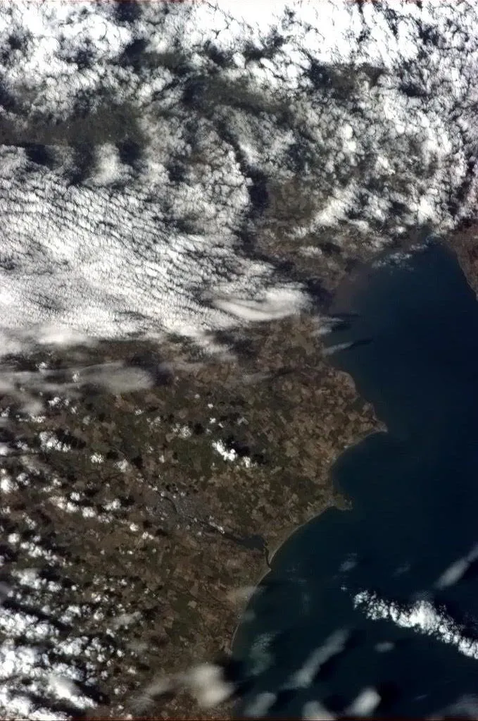 Photo showing: "Drogheda, Ireland, with surrounding counties Louth and Meath obscured by cloud." – Caption by astronaut Chris Hadfield on board the International Space Station.
This is one of a set of eight pictures of Ireland taken from earth orbit that were posted on the internet by Hadfield to celebrate Saint Patrick's Day in 2013.

The town of Drogheda on the River Boyne, seven kilometres from the east coast of Ireland, is near the bottom of the picture, with the inset of Dundalk Bay above the centre of the picture. The original image has been rotated 90 degrees to the left to present a more familiar orientation.