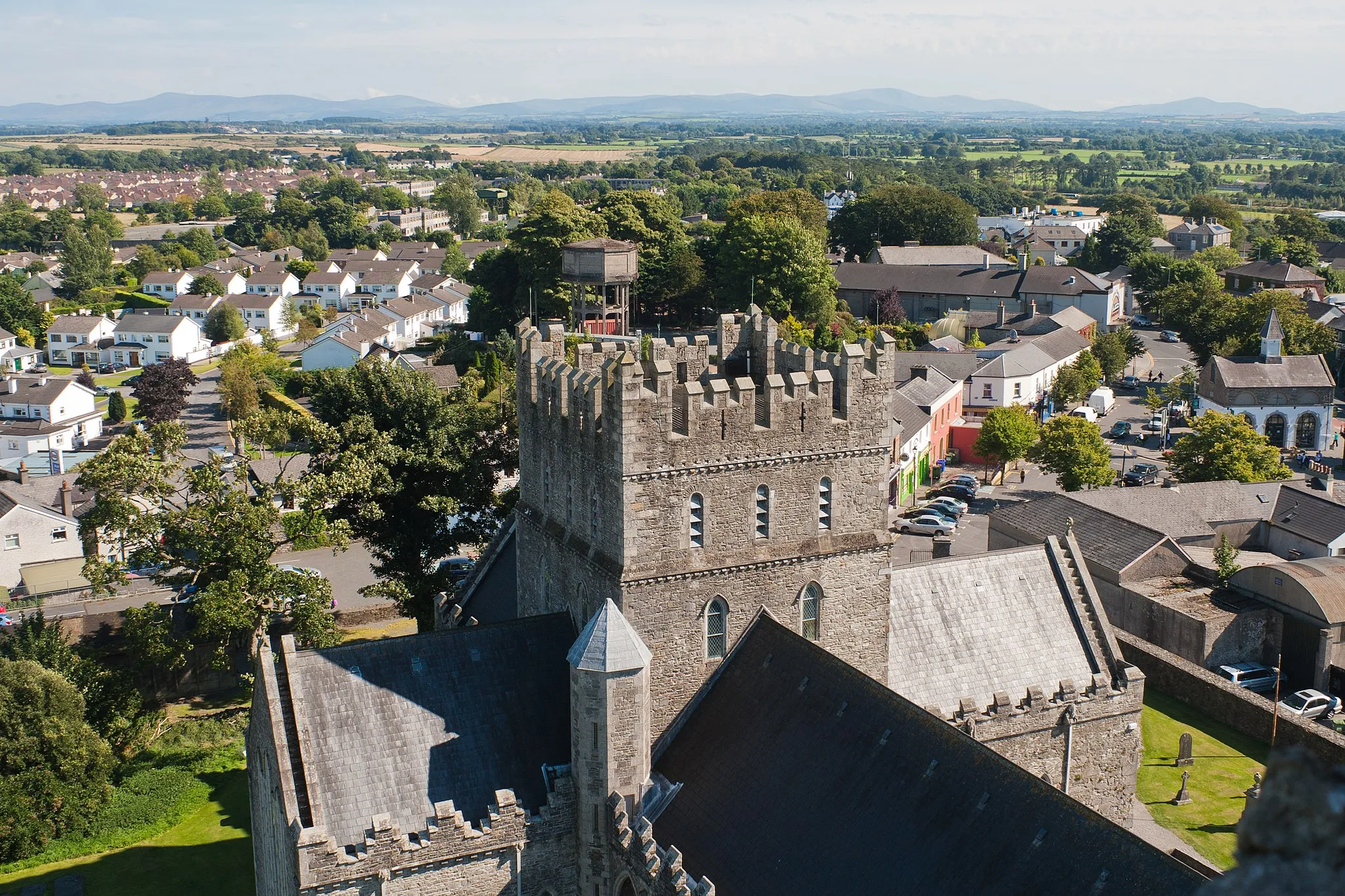 Photo showing: Tower and transepts of the cathedral as seen from the top of the round tower with the Wicklow mountains at the horizon.