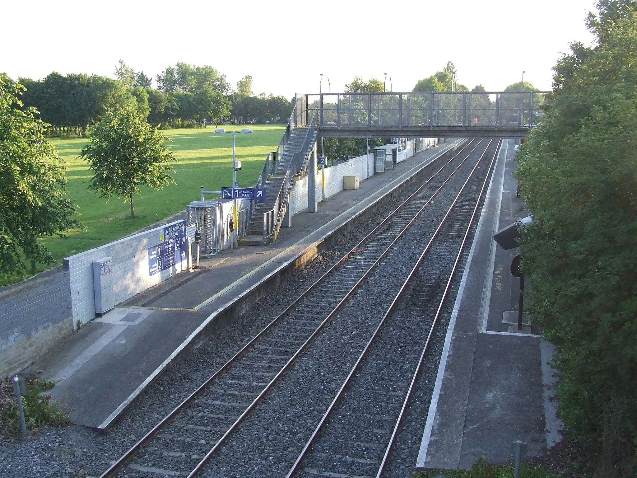 Photo showing: Looking west along the railway from the top of Granard Bridge near the 12th lock of the Royal Canal. Midsummer's Day, an hour before sunset, 2014.