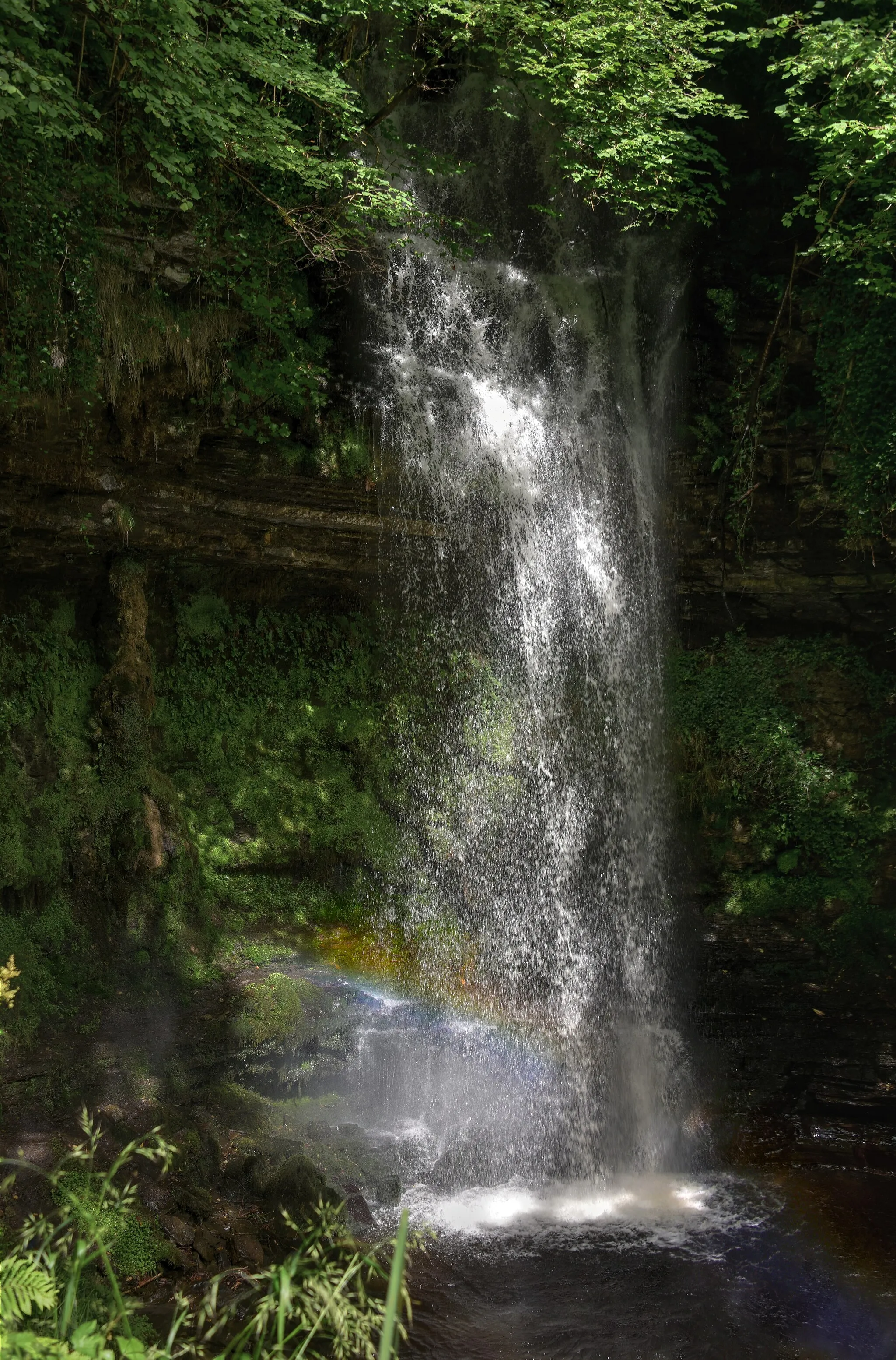 Photo showing: A small rainbow visible in the spray from Glencar Waterfall in County Leitrim, Ireland.
