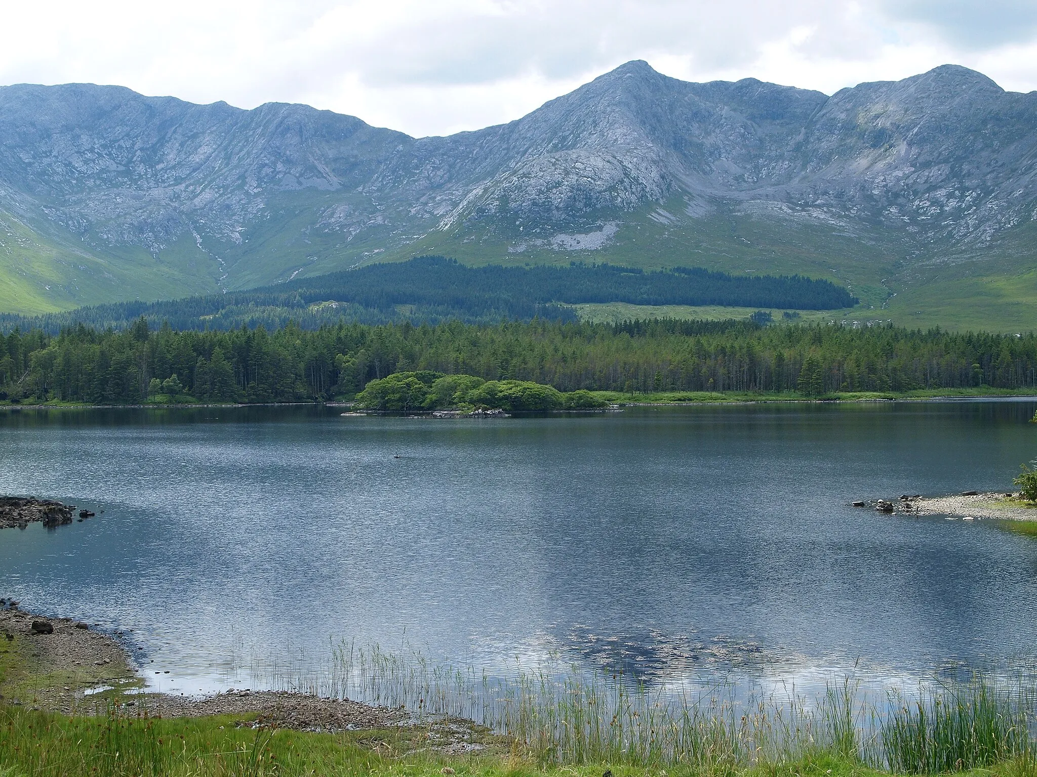 Photo showing: Twelve Bens of Derryclare (left), Bencorr (centre) and Bencorr NE Top (right), across Lough Inagh, Galway, Ireland.  The two cories of with the corries of Log an Choire Mhóir (left) and Log an Choire Bhig (right) are also clearly shown