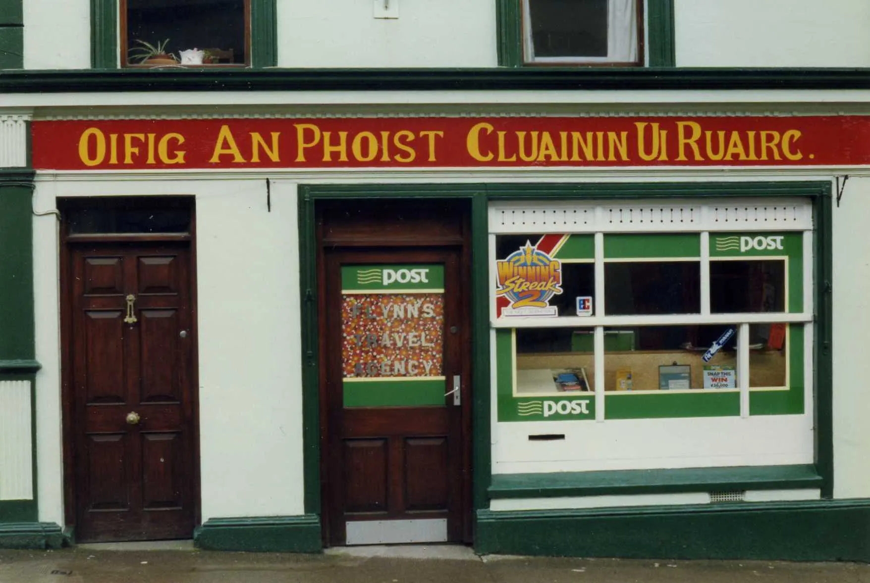 Photo showing: The signwriting is particularly fine and naive, with interesting variations in spacing and thickness of letters. I love it.  One would not guess as a non Irish speaker that the translation of Cluainin ui Ruiarc was Manor Hamilton  Looks like Clon O'Rourke. No doubt the translation was imposed  in the 17th century.