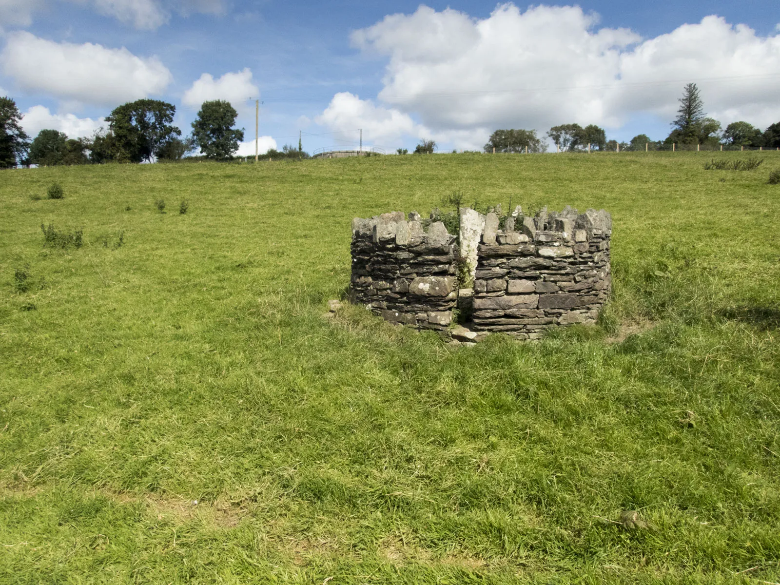 Photo showing: Cross-slab and modern agricultural tank