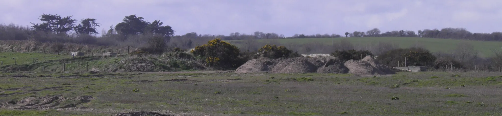 Photo showing: Photograph taken at the beach near Kilmuckridge, County Wexford in Ireland showing part of the damaged area, cropped for size reasons. Water troughs, weeds, dung and contaminated sand/gravel remained on-site and are due to be removed by order.