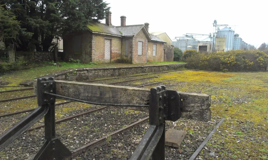 Photo showing: Mogeely Station More has been preserved here than at most abandoned railway stations. Three sets of tracks (one is a central siding) can still be seen along with the station house. The small signal building has now gone, but the signal levers are still there behind the goods shed.
