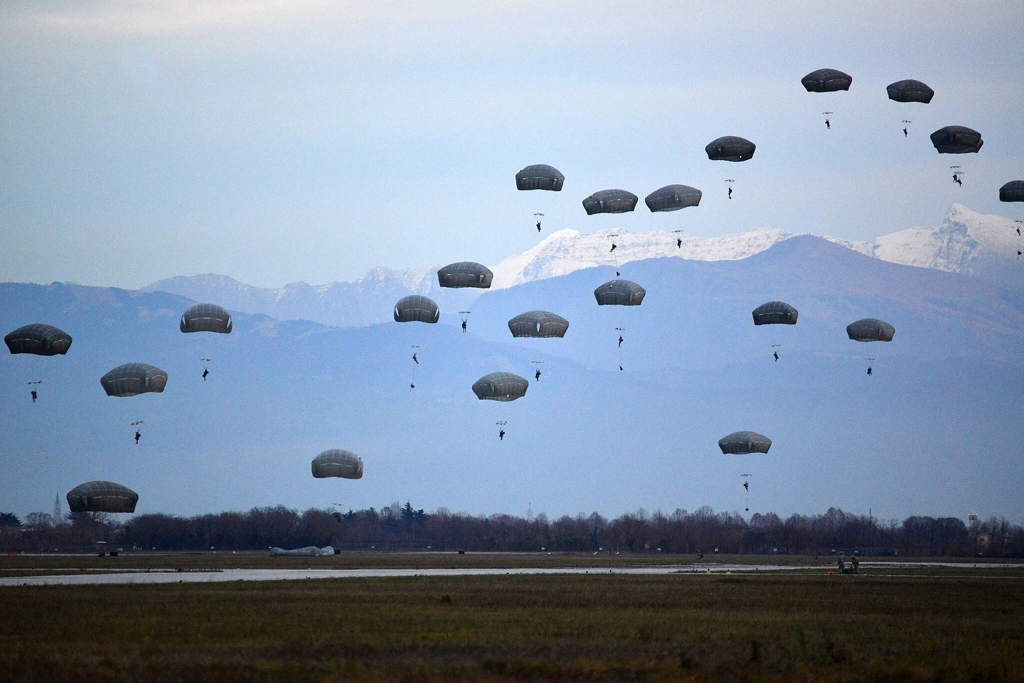 Photo showing: Paratroopers from the 2nd Battalion, 503rd Infantry Regiment, 173rd Airborne Brigade conduct an airfield seizure at dusk at Rivolto Italian Air Force Base Dec. 10, 2014. The battalion conducted airfield seizure training at to sustain their readiness as the U.S. Army's Contingency Response Force in Europe. (Photo by Graigg Faggionato)