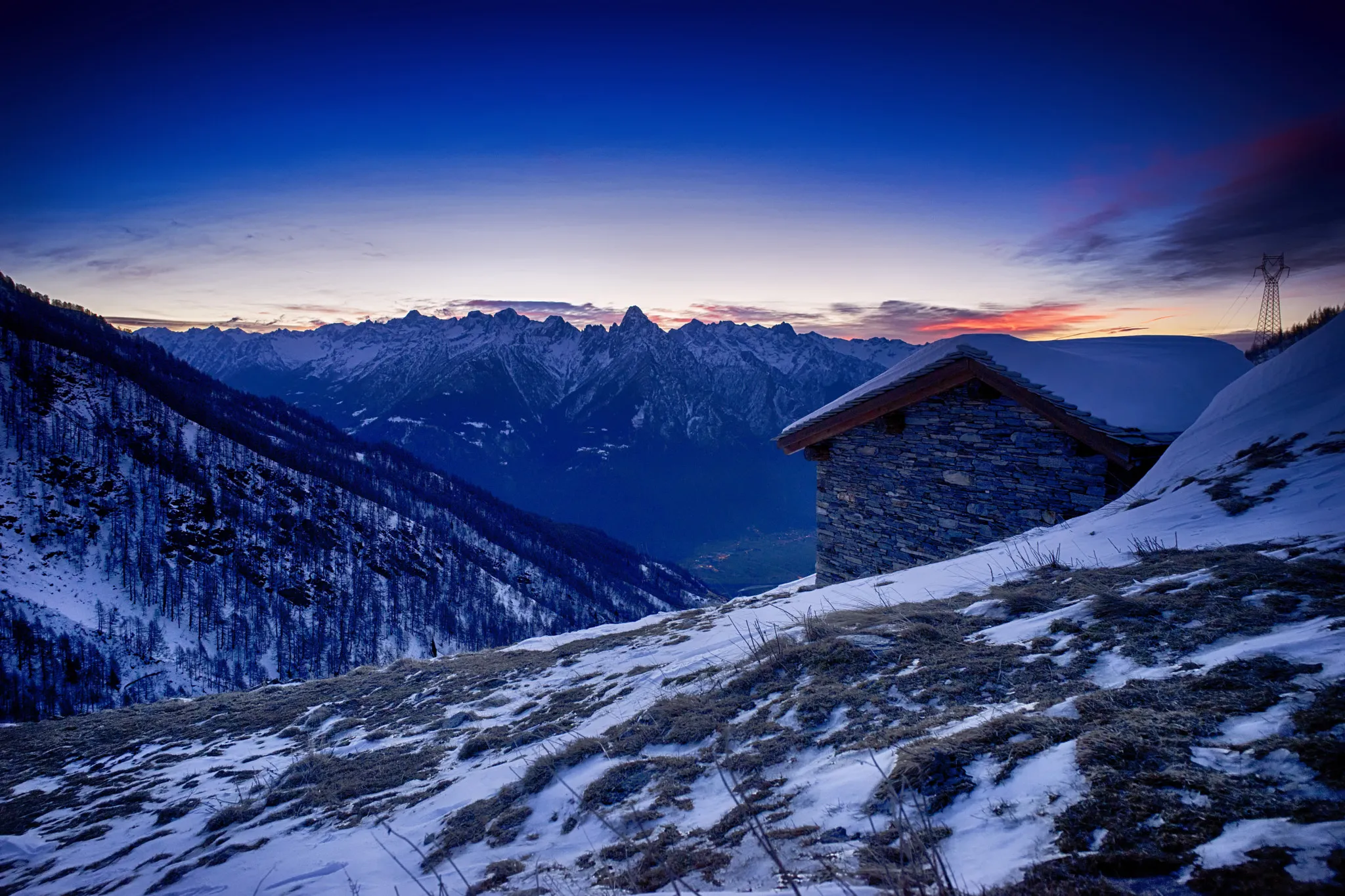 Photo showing: 500px provided description: Bivacco Forcola, Val Chiavenna (Italy)

After having spent the night sleeping in the house visible in the picture, the new day welcomed me with a beautiful and peaceful sunrise. [#landscape ,#sunrise ,#mountains ,#snow ,#alps ,#dusk ,#hut]
