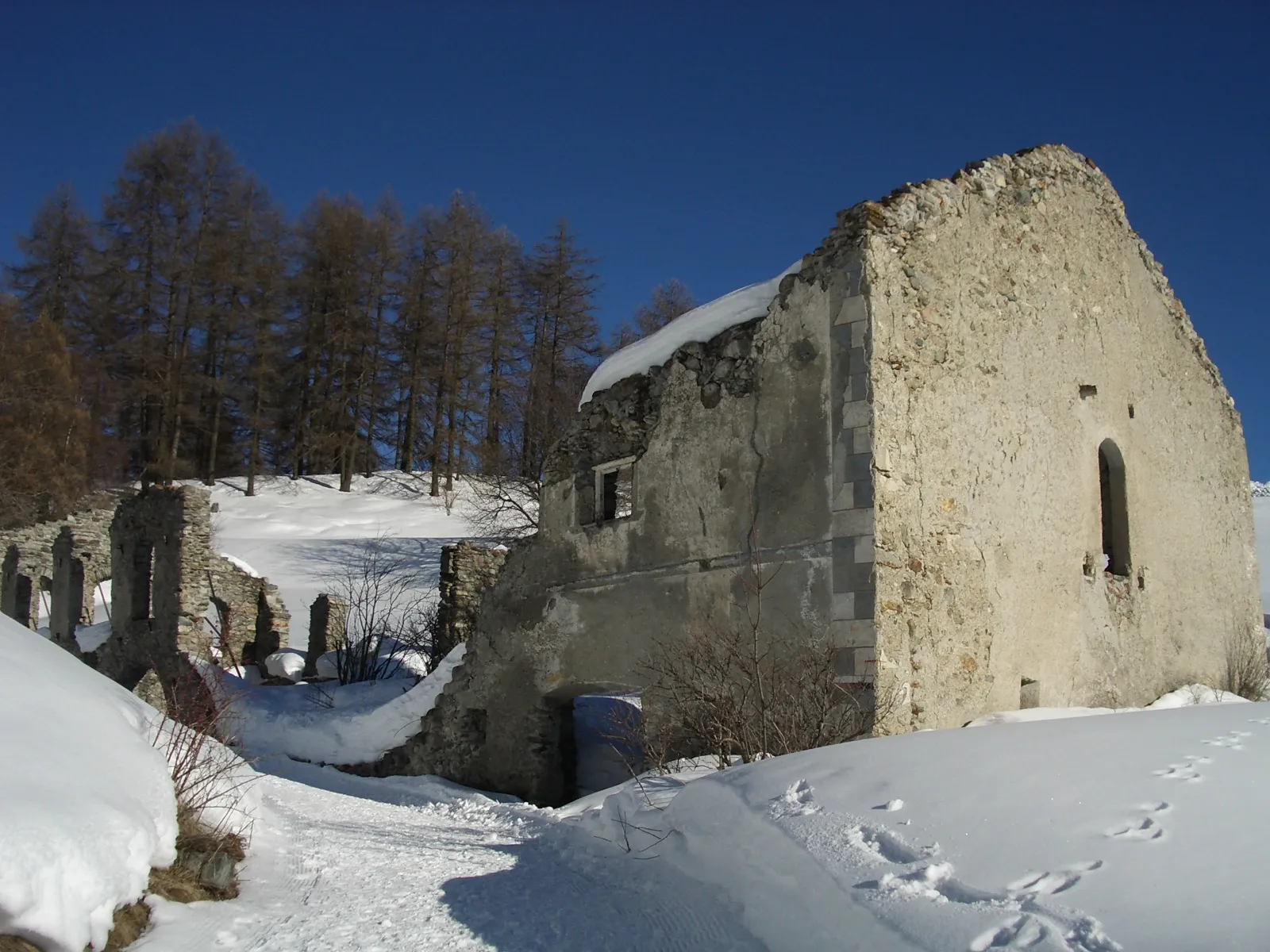Photo showing: Ruine der ehemaligen Sust (fiskalische Taberne) Chanoua, Ardez GR, Schweiz: kleines Wohnhaus mit grossem Ökonomiegebäude, Heustall mit Rundbögen und direkter Einfahrt