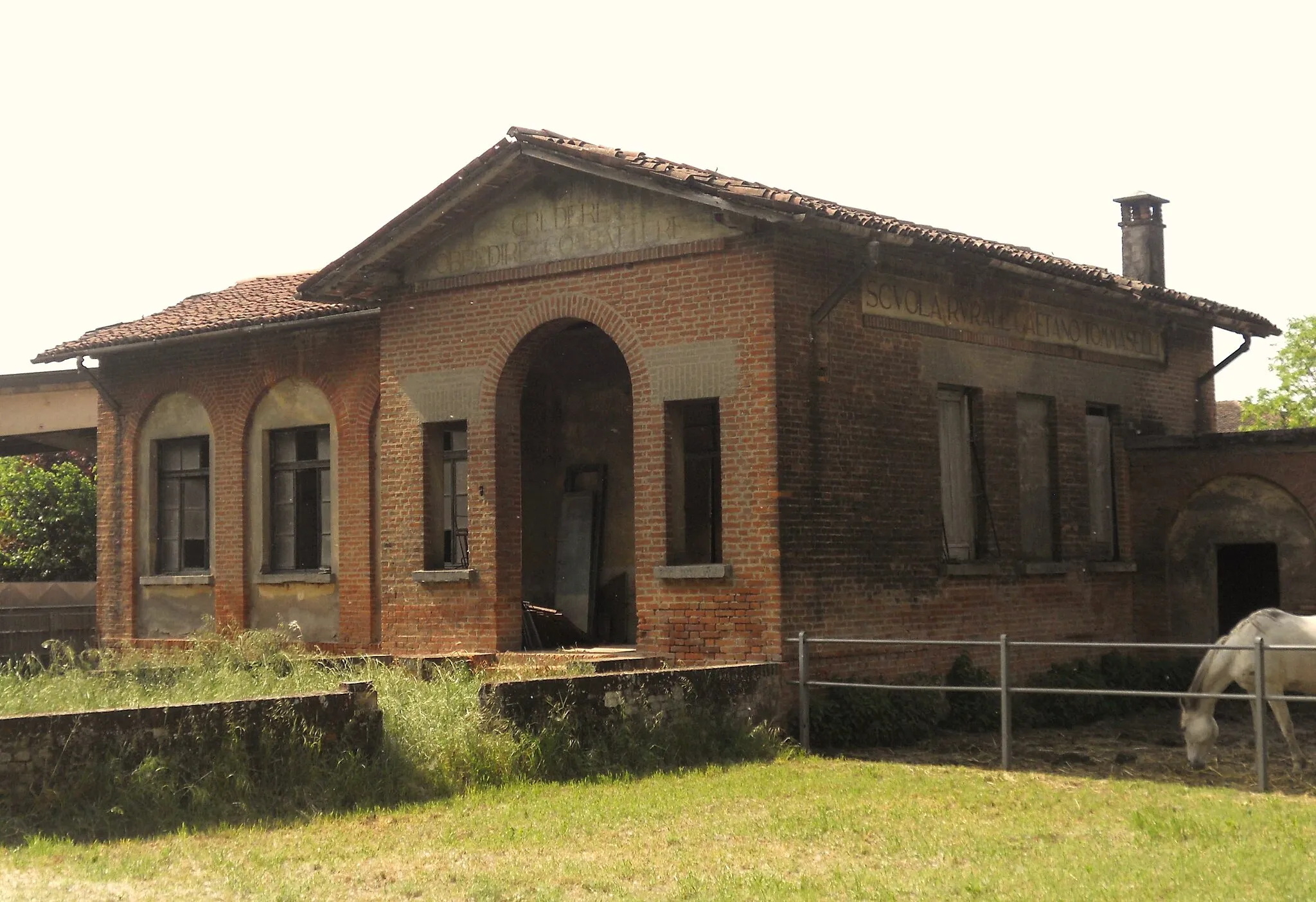 Photo showing: Ex-Italian rural school of the fascist era in the countryside near Castelleone, in Italy. On the front and on the side of the building is written "CREDERE OBBEDIRE COMBATTERE" and "SCVOLA RVRALE GAETANO TOMMASELLI", that literally means "Believe, obey, fight" (a fascist slogan) and "Rural school Gaetano Tommaselli"