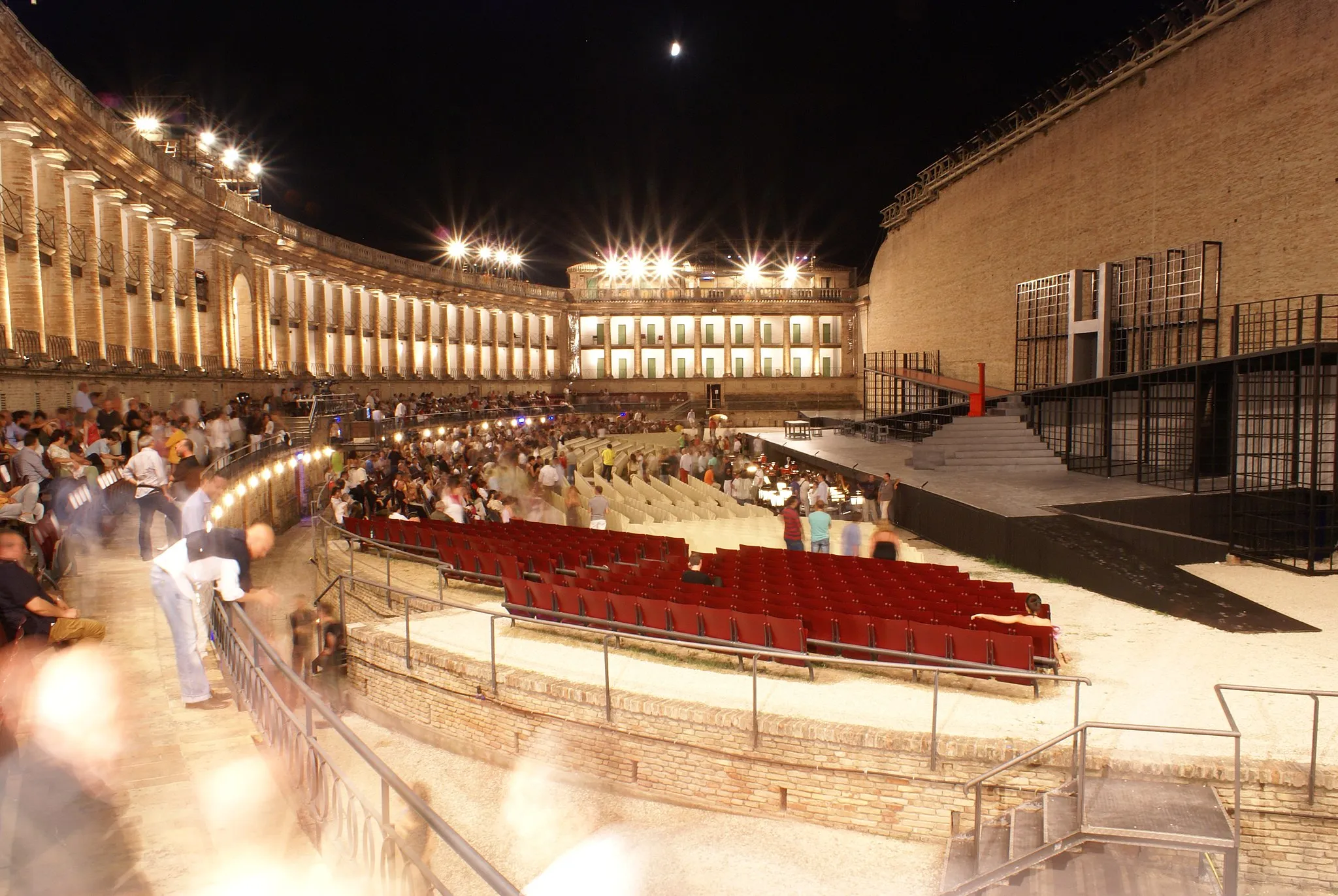 Photo showing: The Sferisterio in Macerata, a large open-air theatre erected from 1820 to 1829 as a playing field for a local ball game, now houses a yearly opera festival in the summer. Its website can be found at [1]. Here, the Sferisterio is shown two nights before the Premiere of the summer 2007 opera festival. The dress rehearsal of "Macbeth" is about to start.
