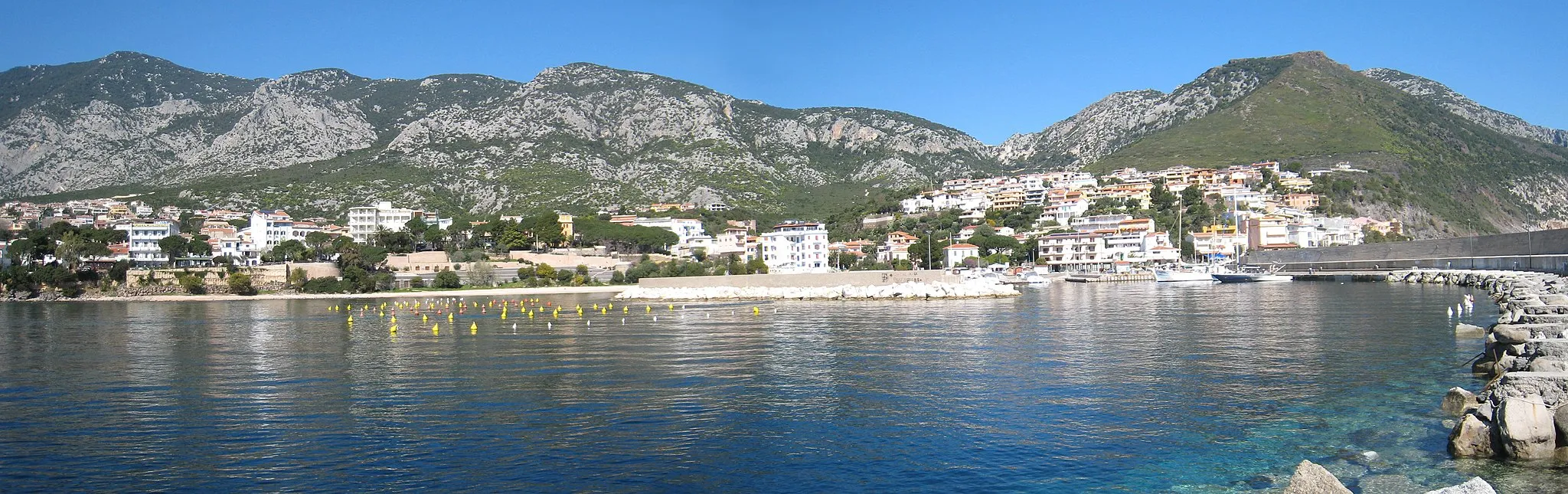 Photo showing: The town of Cala Gonone, seen from the pier.
Composed of two shots stitched together.