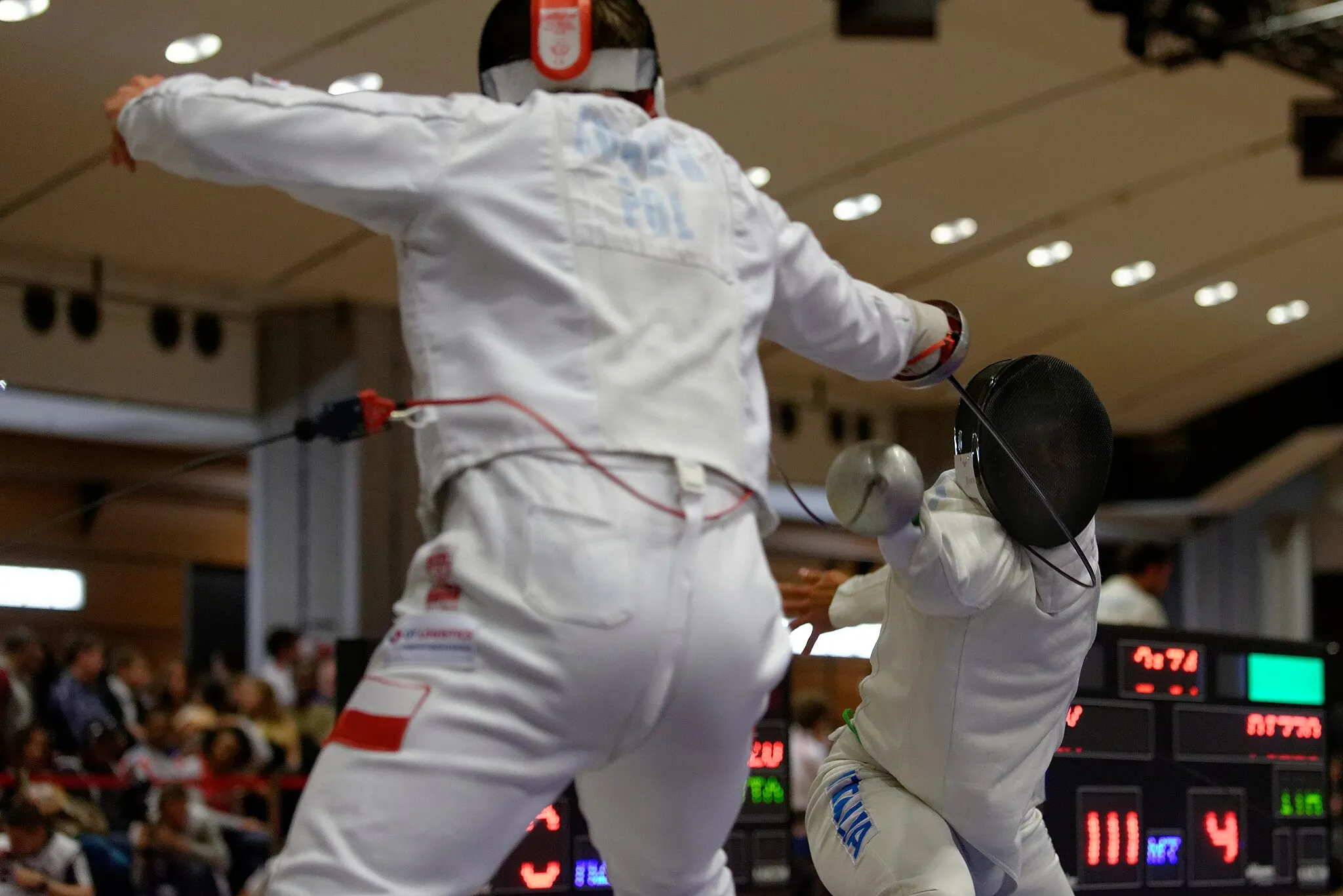 Photo showing: Michał Adamek of Poland (L) fences against Italy's Paolo Pizzo (R) in the T32 of the Challenge Réseau Ferré de France–Trophée Monal 2013, a men's épée FIE World Cup competition. Louvre Carrousel, Paris.