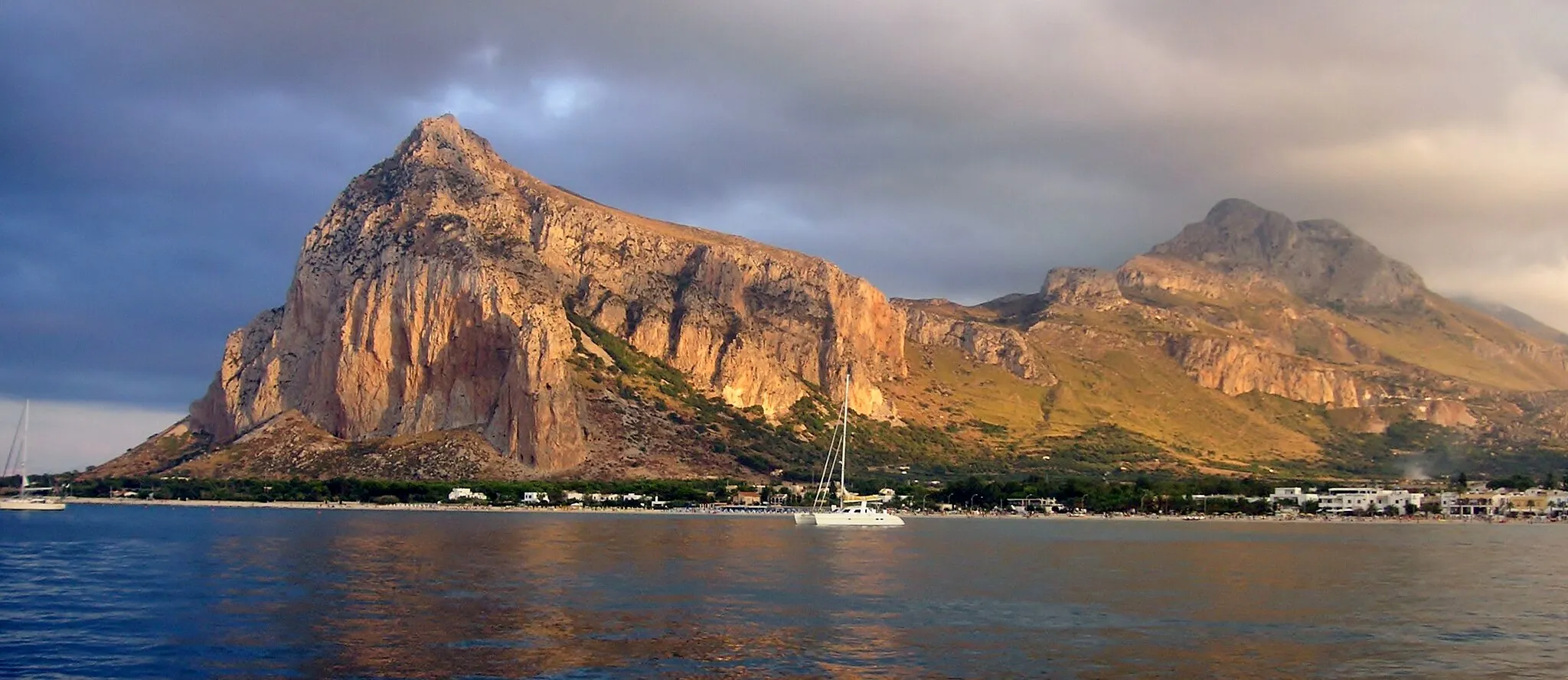 Photo showing: View from enter to San Vito La Capo marina, showing coast of city and mountains behind of it.
San Vito Lo Capo,
Sicily,

Italy