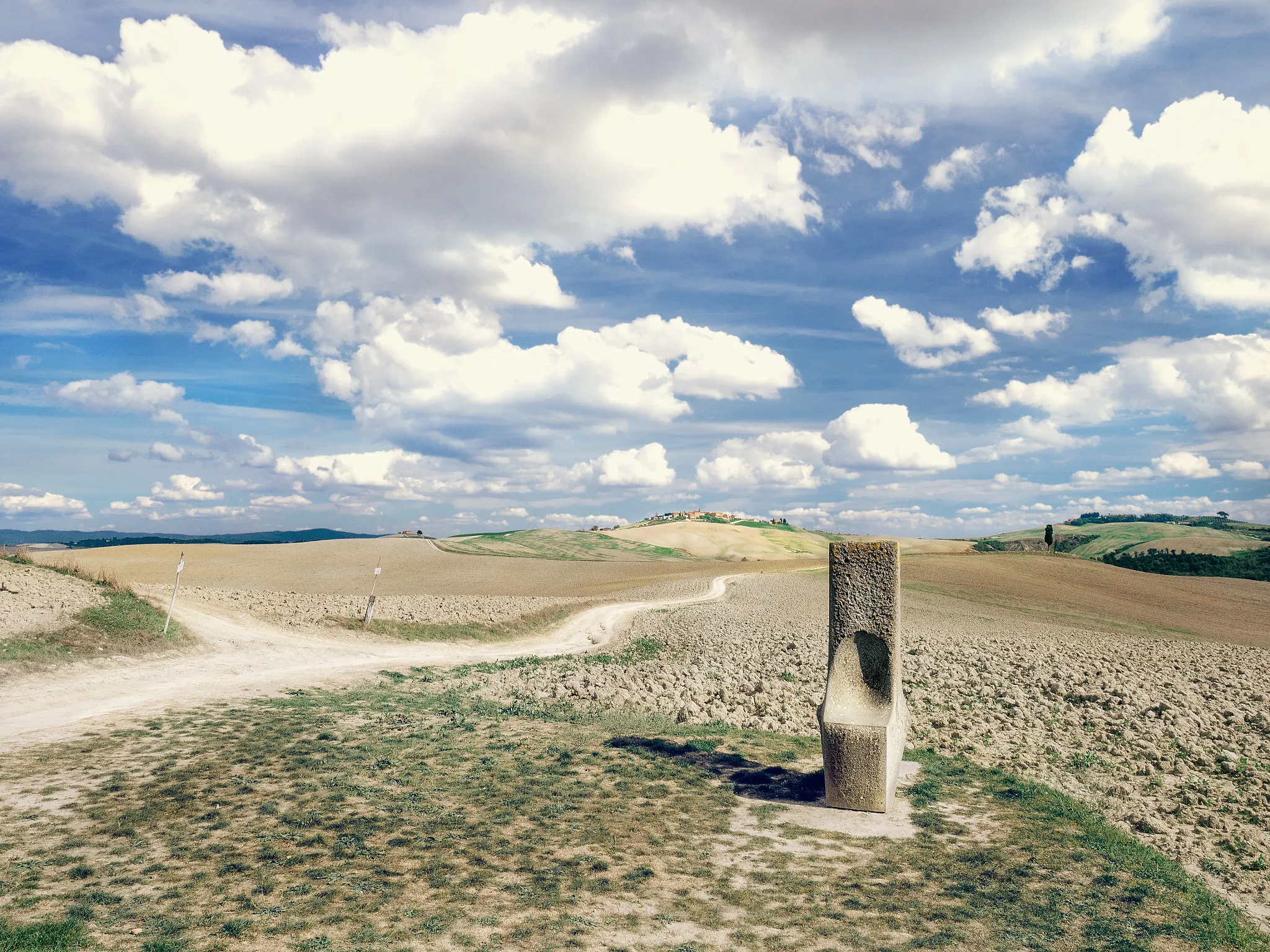 Photo showing: 500px provided description: At the junction I take a seat 
to stop the rotation of the earth.

? For a while. [#field ,#sky ,#clouds ,#europe ,#italy ,#way ,#path ,#chair ,#seat ,#stone ,#fields ,#crossing ,#toscana ,#dry ,#tuscany ,#junction ,#agrarian ,#Mucigliani]