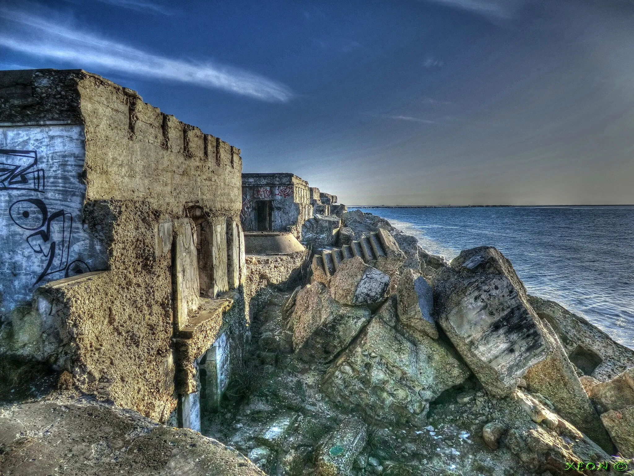 Photo showing: Every Day The Sea Devours Coasts Battary